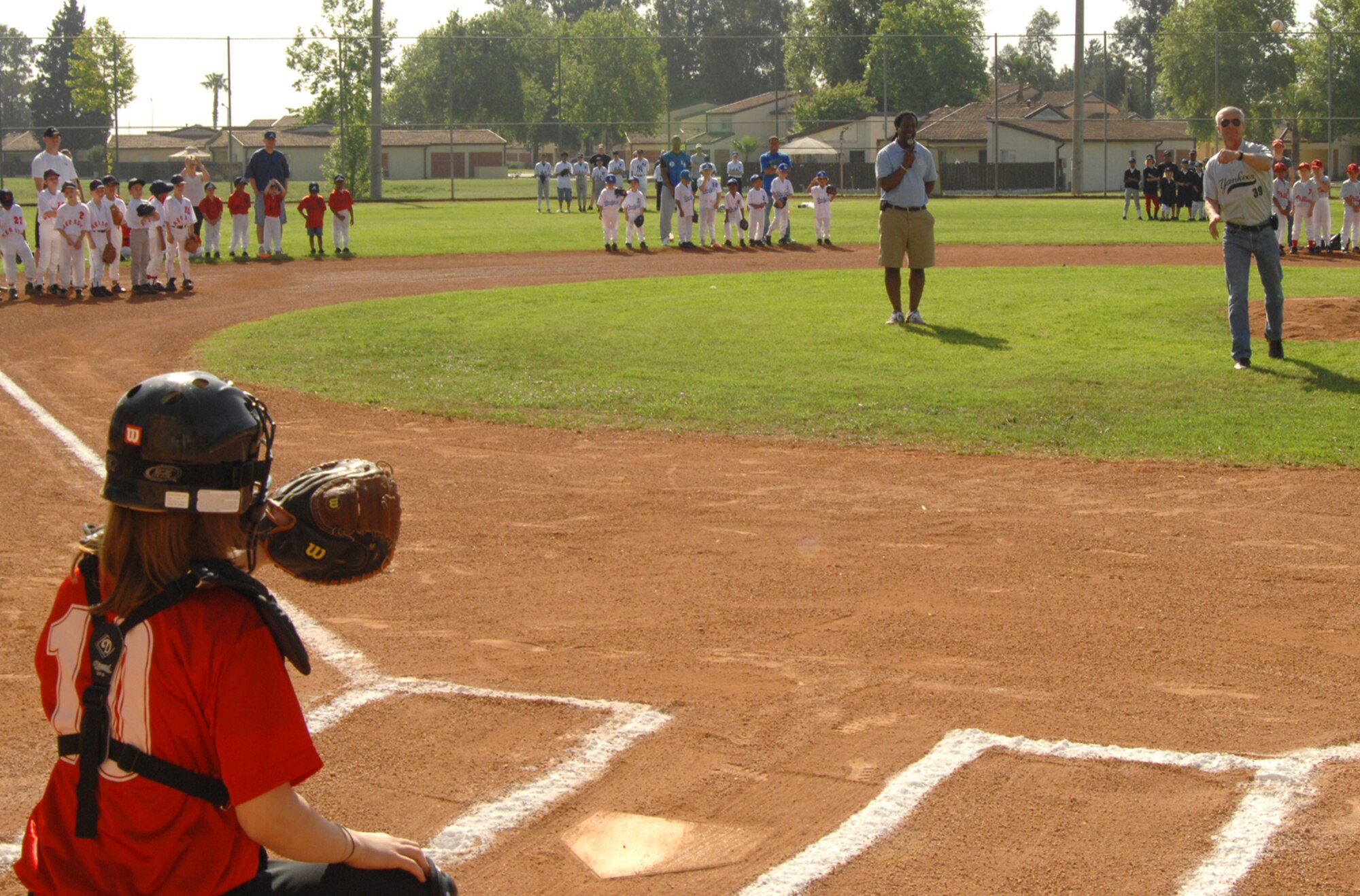 Col. Phil McDaniel, 39th Air Base Wing commander, throws the ceremonial first pitch to Daniel Dorris, catcher for the Red Sox, at the Incirlik Youth Baseball League opening ceremony April 19. There are 13 teams in the league rangng from 5-6 year olds in tee ball to 12-14 year olds in the majors. The Red Sox are one of two teams in the major league category. (U.S Air Force photo by Senior Airman Heather Stanton)