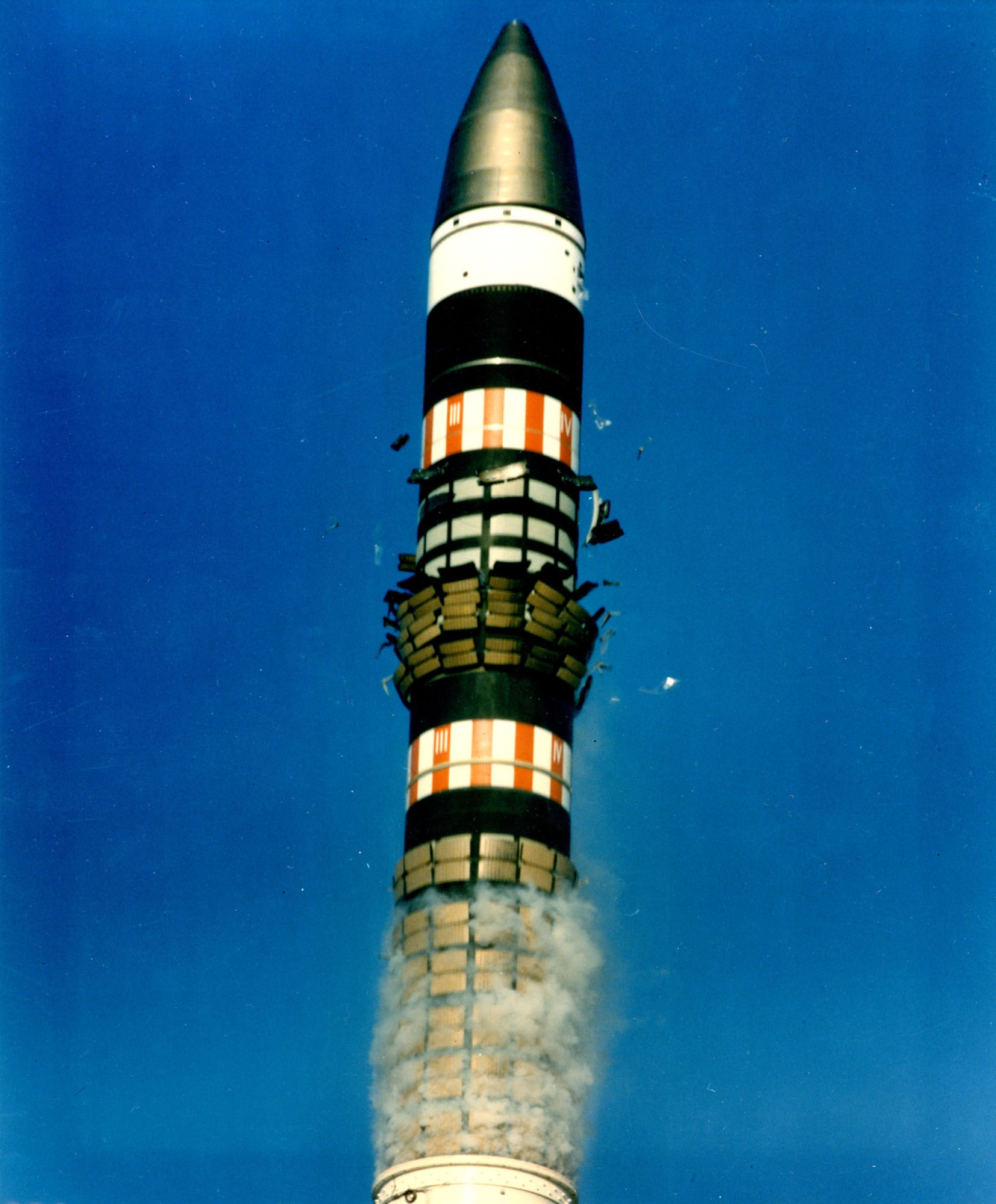 Shock-absorbing tiles, which help the missile exit its canister, fall away as Peacekeeper is launched. (U.S. Air Force photo)