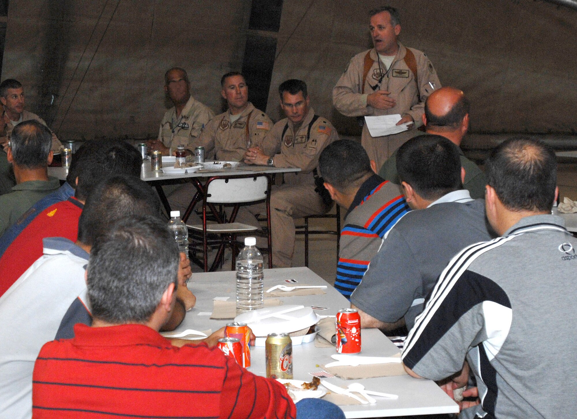 Lt. Col. James Adamski, 52nd Expeditionary Flying Training Squadron instructor pilot, addresses the crowd of a recent Order of Daedalians meeting here. The event marked the first Daedalian meeting that Iraqi pilots were invited to participate. Most of the U.S. pilots who attended the meeting are assigned to the Coalition Air Forces Training Team - an organization dedicated to training Iraqi airmen at their flying training wing here. (U.S. Air Force Graphic Illustration by Senior Master Sgt. Don Senger)