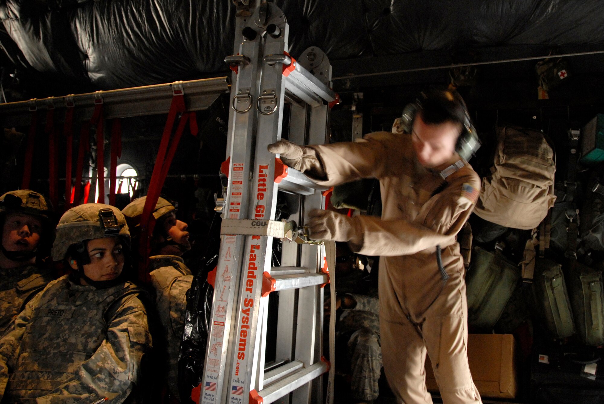 SOUTHWEST ASIA -- Senior Airman Zachary Kelhi, a C-130 Hercules loadmaster deployed to the 737th Expeditionary Airlift Squadron, secures a ladder to the aircraft in preparation for the take-off of a combat sortie that transported Soldiers into Iraq April 21, 2008, from an air base in the Persian Gulf Region. The Air Force recently surpassed more than one million sorties flown by Air Force aircraft in the Global War on Terror since Sept. 11, 2001. Synchronized and integrated into larger coalition air efforts, these missions represent the most deliberate, disciplined and precise air campaign in history. Airman Kelhi is deployed from the 39th Airlift Squadron, Dyess Air Force Base, Texas. (U.S. Air Force photo/ Staff Sgt. Patrick Dixon)
