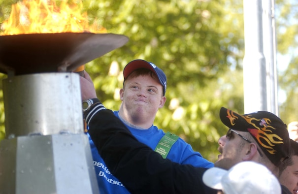 Athlete Bryan Hogg, Kaiserslautern American High School ninth grader, ignites the Olympic flame at the 2007 U.S. Army Garrison Kaiserslautern Special Olympics Spring Games at the Police Academy in Enkenbach-Alsenborn. Photo by Christine June 