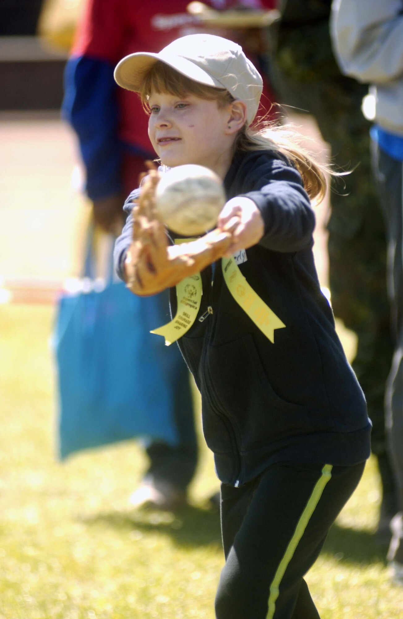 Kimberly Raab, 8, from the Westpfalz Schule in Landstuhl, catches a softball during the competitive fielding event at the 2007 U.S. Army Garrison Kaiserslautern’s Special Olympics Spring Games at the Police Academy in Enkenbach-Alsenborn. Photo by Christine June 