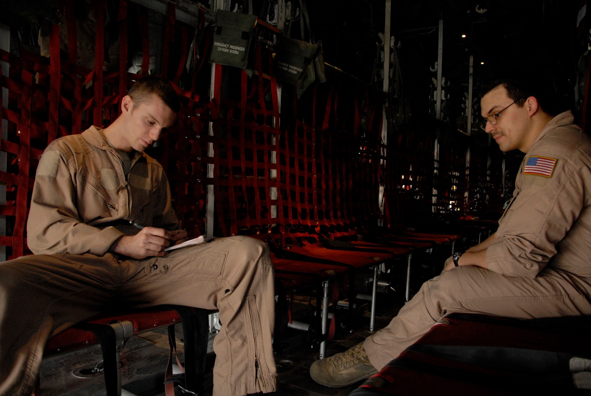 SOUTHWEST ASIA -- Senior Airman Zachary Kelhi (left) and Airman 1st Class Armando Baez, both C-130 Hercules loadmasters deployed to the 737th Expeditionary Airlift Squadron, calculate the weight and balance of a C-130 Hercules prior to the take-off of a combat sortie that transported Soldiers into Iraq April 21, 2008, from an air base in the Persian Gulf Region. The Air Force recently surpassed more than one million sorties flown by Air Force aircraft in the Global War on Terror since Sept. 11, 2001. Synchronized and integrated into larger coalition air efforts, these missions represent the most deliberate, disciplined and precise air campaign in history. Airmen Kelhi and Baez are both deployed from the 39th Airlift Squadron, Dyess Air Force Base, Texas. (U.S. Air Force photo/ Staff Sgt. Patrick Dixon)