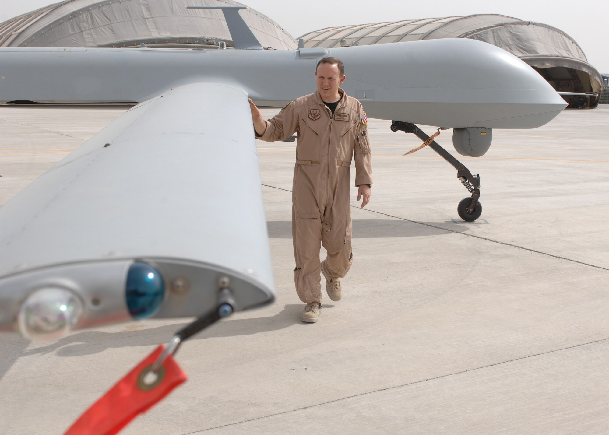 BAGRAM AIR FIELD, Afghanistan - Maj. Lichen Pursley, 62nd Expeditionary Reconnaissance Squadron commander, performs a pre-flight inspection on an MQ-1 Predator before a combat mission in Afghanistan. The unit’s primary role is to launch and recover Predators supporting Operation Enduring Freedom. (U.S. Air Force photo by Master Sgt. Demetrius Lester)