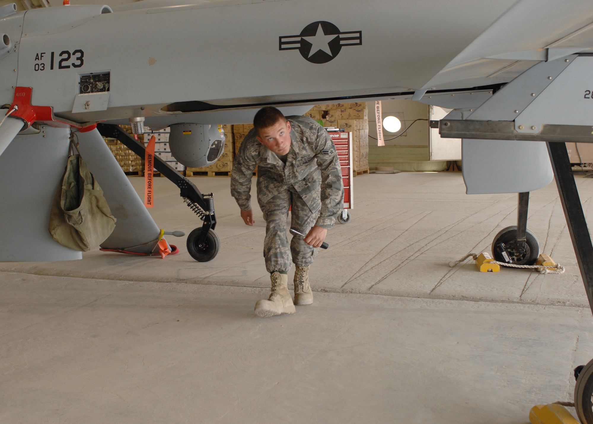 BAGRAM AIR FIELD, Afghanistan - Airman 1st Class Troy Spence, 62nd Expeditionary Reconnaissance Squadron crew chief, inspects a MQ-1 Predator during routine maintenance in Afghanistan. The unit’s primary role is to launch and recover Predators supporting Operation Enduring Freedom. Airman Spence is deployed from the 432nd Aircraft Maintenance Squadron, Creech Air Force Base, Nev. (U.S. Air Force photo by Master Sgt. Demetrius Lester)