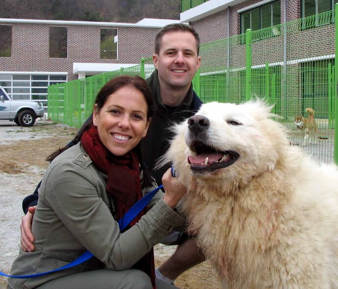 Stephanie Mounts and her husband, Lt. Col. Steve Mounts, 51st Medical Support Squadron commander, pose with Tahoe, the newest addition to their family. (U.S. Army photo/Stacy A. Ouellette)