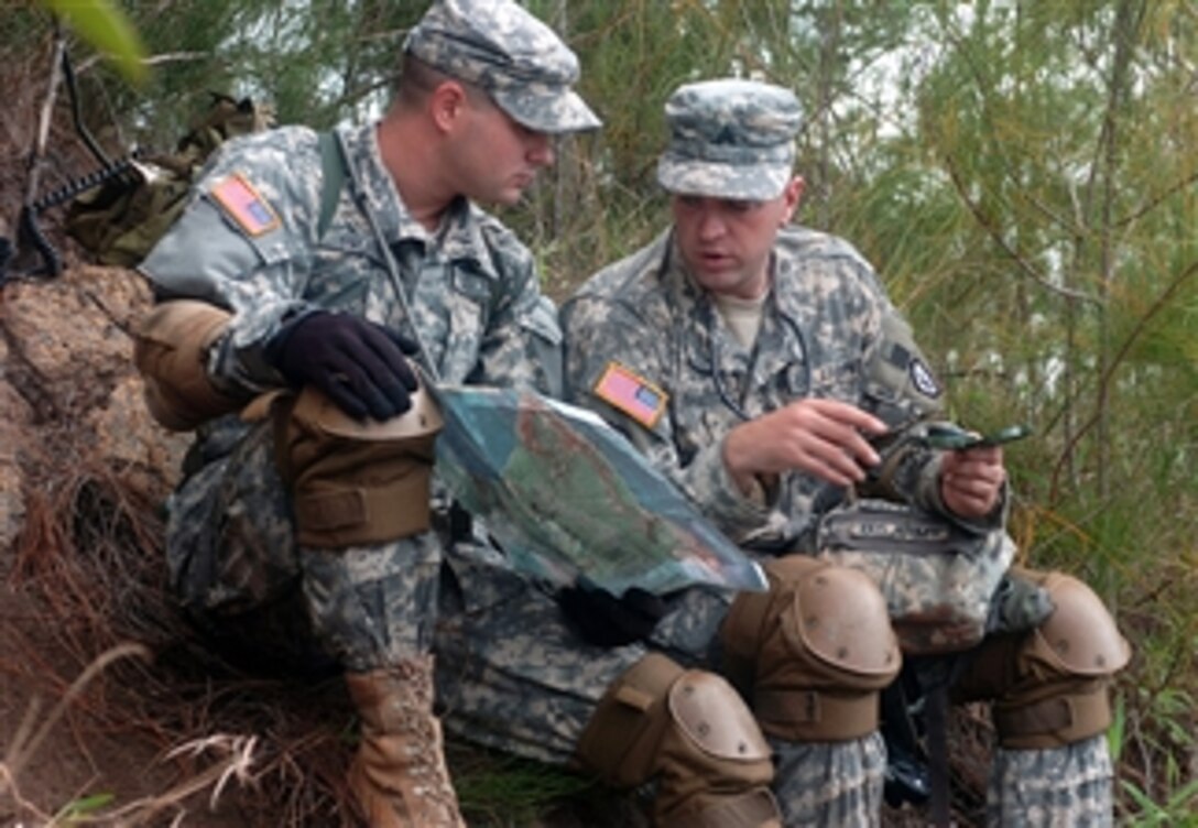 U.S. Army Pvt. Juston Grubbs and Sgt. Thomas Tallman review maps and compasses to prepare for a fire exercise at Dillingham Airfield, Hawaii, April 23, 2008. The soldiers area assigned to the 2nd Squadron, 6th Cavalry Regiment, 25th Combat Aviation Brigade.