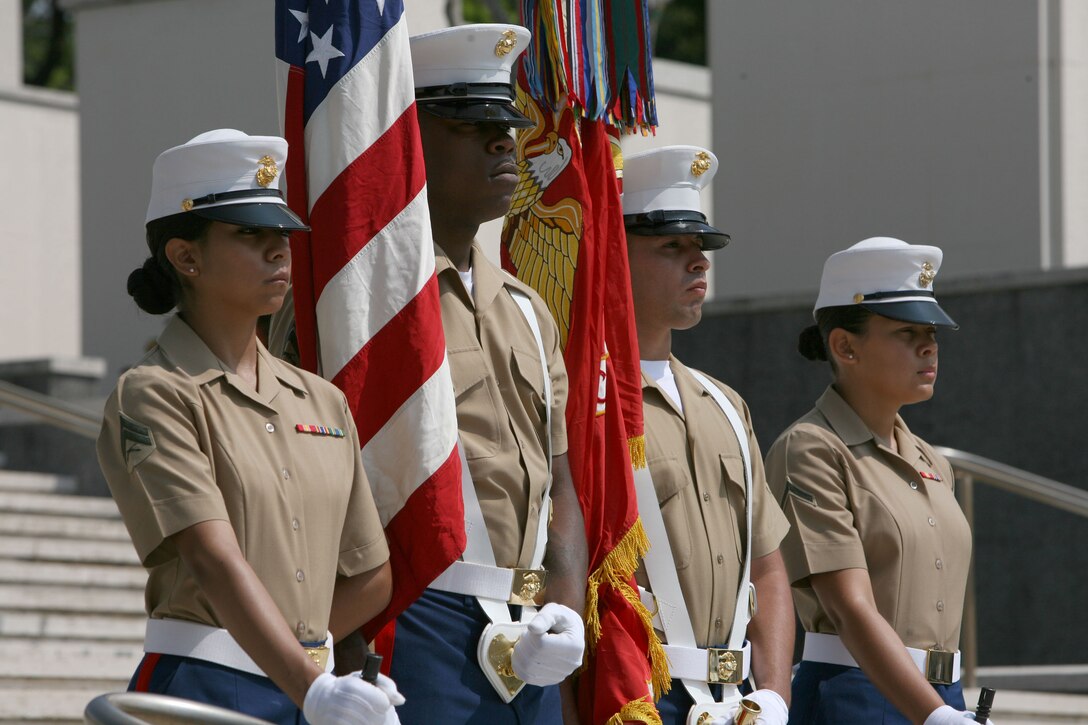 Sgt. LaVonne A. Watkins, 2nd from the left, holds the American flag as part of the color guard during  Australian and New Zealand Army Corps day at the National Memorial Cemetery of the Pacific (Punchbowl) here, April 25. Watkins, MarForPac electronic key management system alternate manager, is the color sergeant and participates in different events with the color guard.