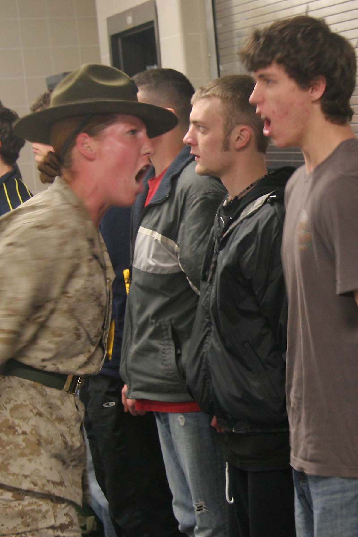 CAMP RIPLEY, Minn.- Sgt. Bobi M. Severyn, a drill instructor with 4th Battalion, , Marine Corps Recruit Depot Paris Island, S.C., shows a poolee just how loud he needs to sounds off during RS Twin Cities' Annual Mini-Boot Camp April 25-27. Photo by Staff Sgt. Stephen L. Traynham, Recruiting Station Twin Cities