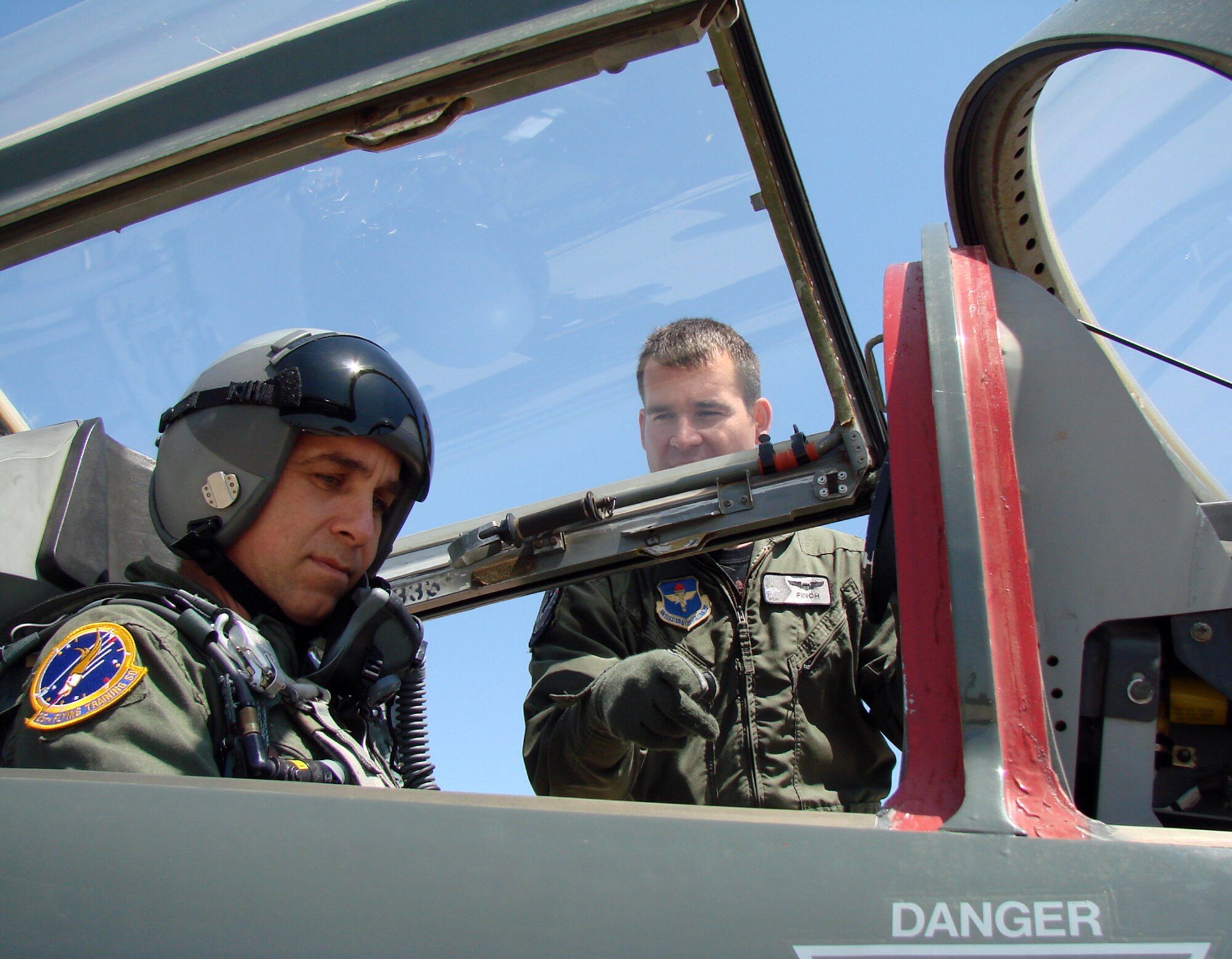 The Honorable Chris Benge, Oklahoma Speaker of the House, is shown how to close a T-38 canopy by Capt. Michael Pickett, 25th Flying Training Wing check flight. Representative Benge visited Vance April 25 for a wing orientation and a T-38 flight. Representative Benge's home district is in Tulsa.