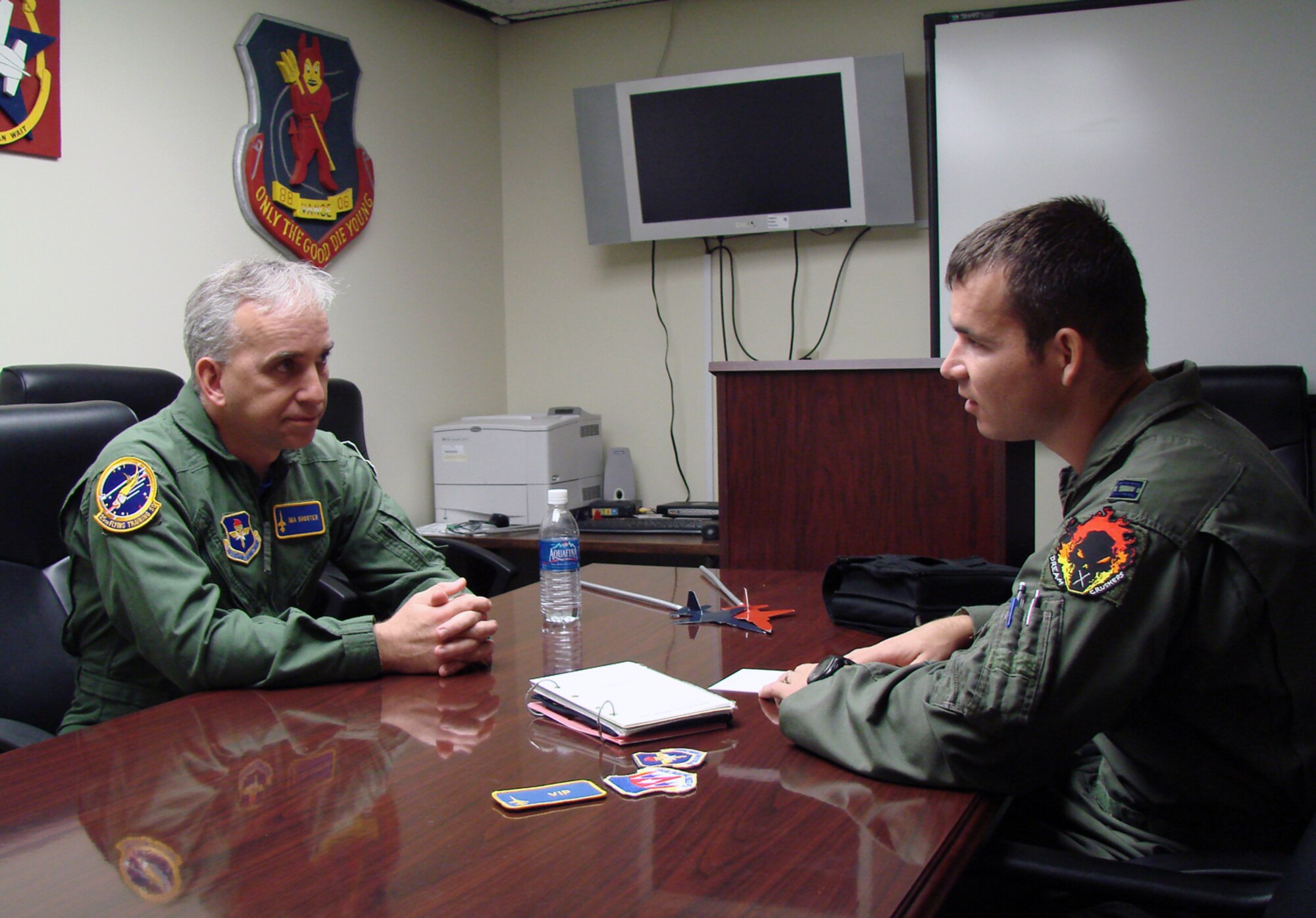 The Honorable Chris Benge, Oklahoma Speaker of the House, goes through a T-38 mission brief with Capt. Michael Pickett, 25th Flying Training Wing check flight. Representative Benge visited Vance April 25 for a wing orientation and a T-38 flight. Representative Benge's home district is in Tulsa.