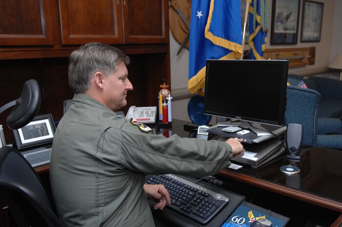 NELLIS AIR FORCE BASE, Nev. - Colonel Michael Bartley, 99th Air Base Wing commander and the head of the base Energy Management Steering Group, turns off his computer at the end of the day in agreement with the base “turn it off” energy saving policy. Col Bartley and the other Nellis senior leaders took a stand on energy conservation. Nellis Energy Management Steering Group has been touted across the Air Force as the example for other organizations to follow. (Air Force photo illustration by Senior Airman Larry E. Reid Jr.)

