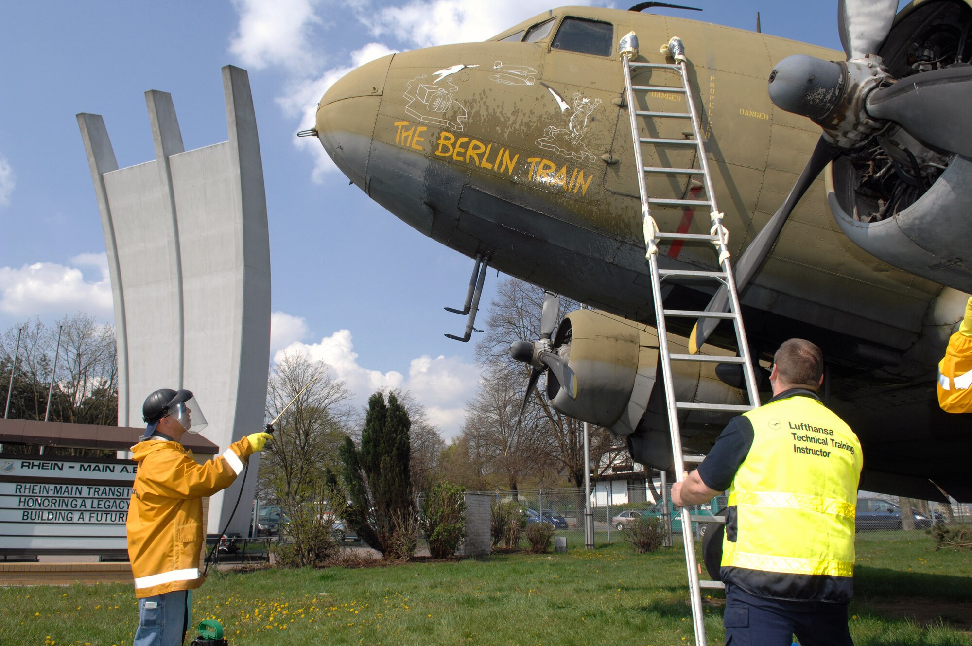 Staff Sgt. Kevin Cloyd rinses the nose art on a static C-47 on display at the Berlin Airlift Memorial site of the former Rhein Main Air Base near Frankfurt International Airport in Germany. Sergeant Cloyd and a team of approximately 30 volunteers from Ramstein AB spent three days cleaning the display aircraft for refurbishing in preparation for a Berlin Airlift 60th Anniversary Celebration to take place there in June. Sergeant Cloyd is an aircraft maintenance crew chief at Ramstein AB. (U.S. Air Force photo/Tech. Sgt. Corey Clements) 