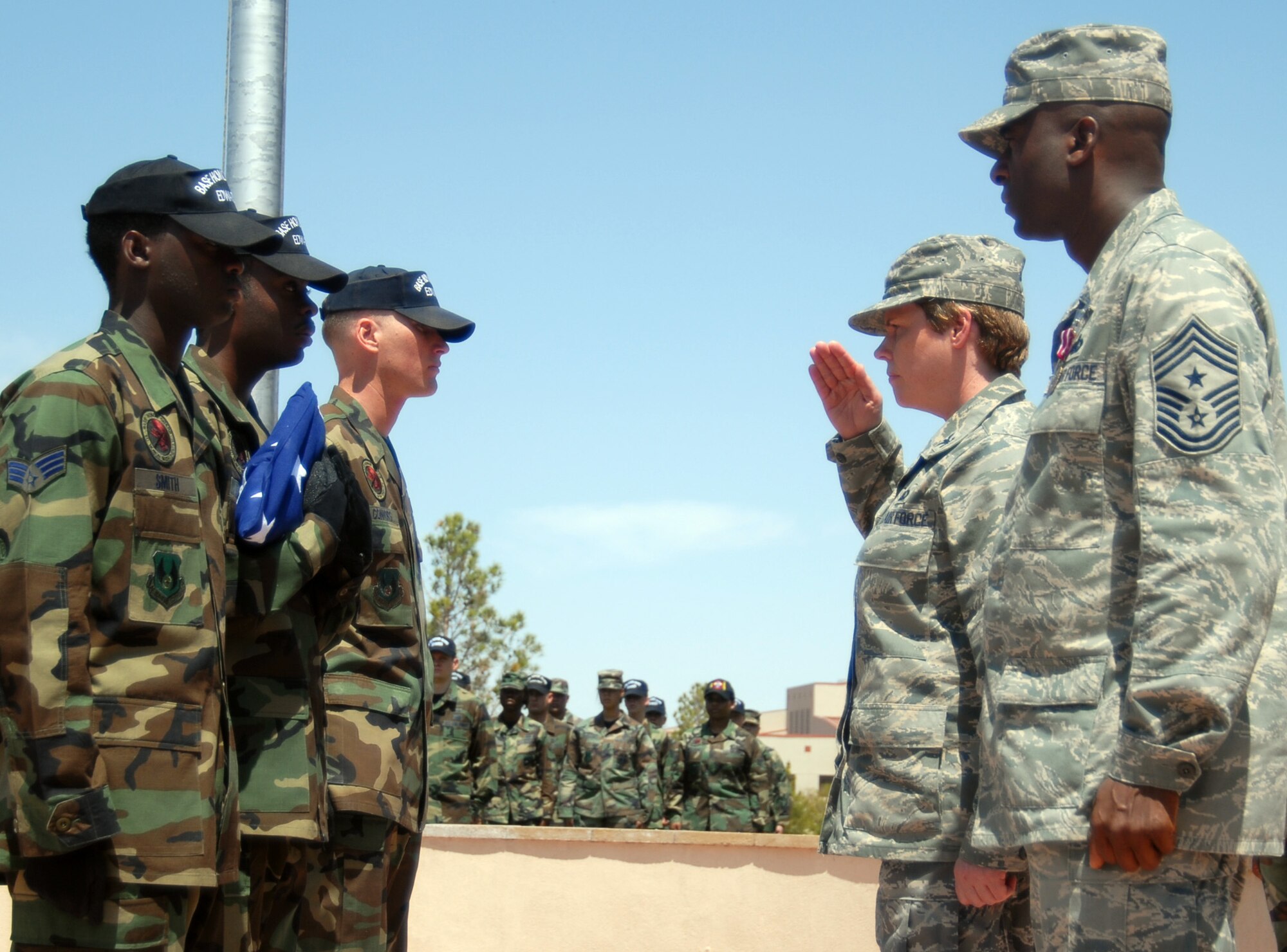 EDWARDS AIR FORCE BASE, Calif. -- Col. Nancy Wharton, 95th Air Base Wing commander, salutes the American flag at the conclusion of the monthly retreat ceremony here April 25. The retreat ceremony, which marked the return of monthly retreat ceremonies for Edwards is in honor of Chief Master Sgt. Juan Lewis, 95th ABW command chief (standing beside Colonel Wharton), who is moving on to be the command chief for the 37th Training Wing at Lackland Air Force Base, Texas. (Air Force photo by Senior Airman Julius Delos Reyes)