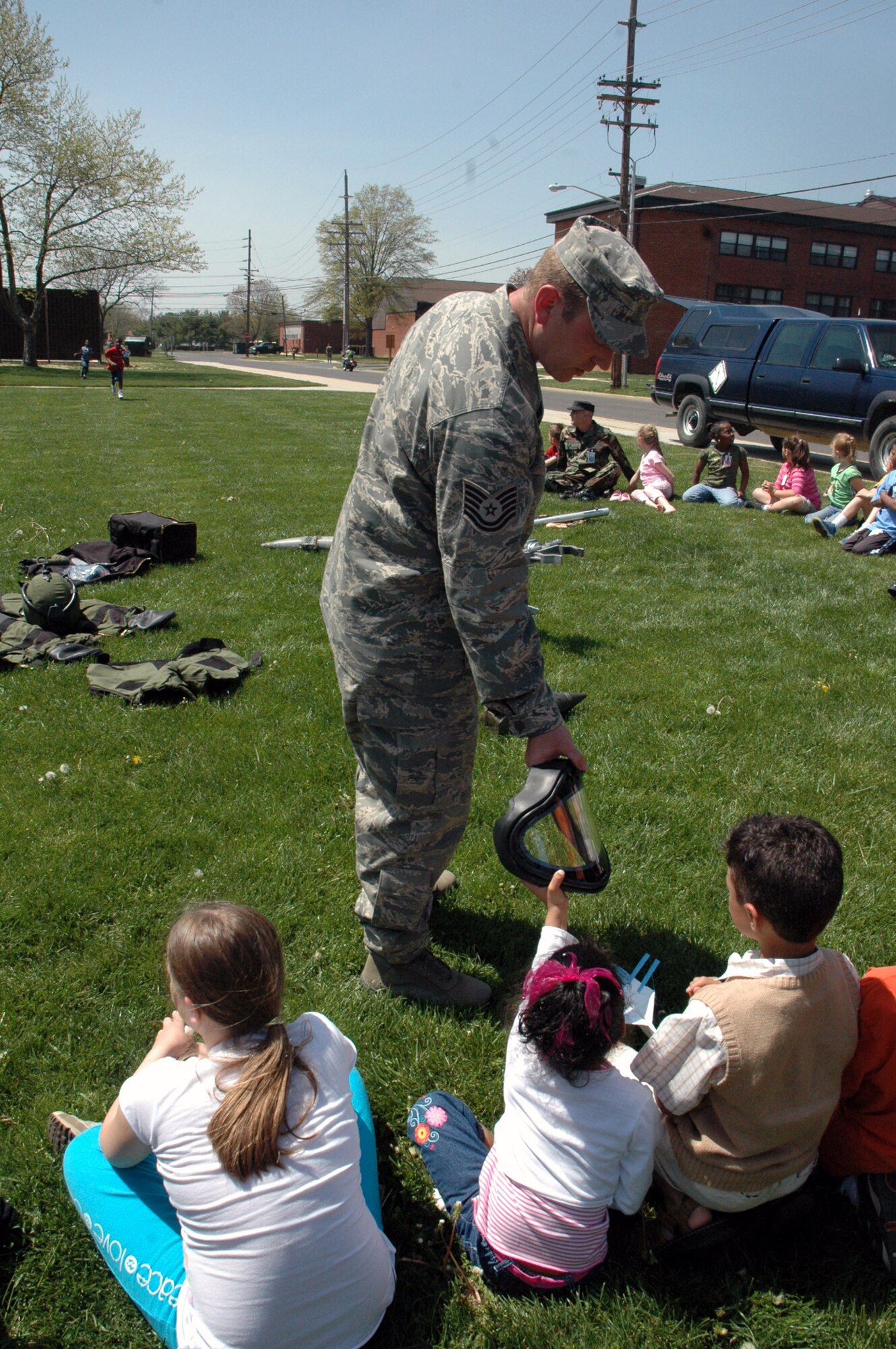 Tech. Sgt. Vandiver Hood, from the U.S. Air Force Expeditionary Center's 421st Combat Training Squadron, shows USAF EC Airmen and their children some of the equipment used by explosive ordnance disposal Airmen as part of a demonstration event for "Take Your Children to Work Day" at the Center on Fort Dix April 24, 2008.  More than 70 children participated in the event. (U.S. Air Force Photo/Tech. Sgt. Scott T. Sturkol)