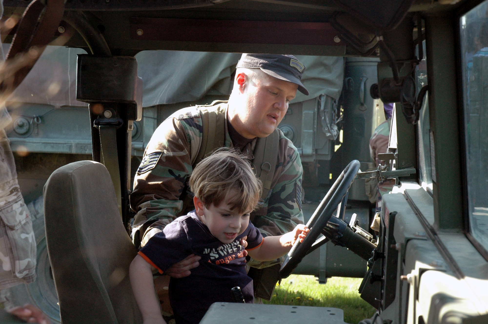 Tech. Sgt. Johnathon Cruikshank, from the U.S. Air Force Expeditionary Center's 421st Combat Training Squadron at Fort Dix, N.J., shows children at the McGuire Air Force Base, N.J., child development center the inside of a HMMWV April 24, 2008, at McGuire.  The demonstration was part of an effort by the 421st CTS who sent several Airmen to the CDCs at McGuire and Fort Dix for a tactical vehicle display and demonstration.  (U.S. Air Force Photo/Tech. Sgt. Scott T. Sturkol)
