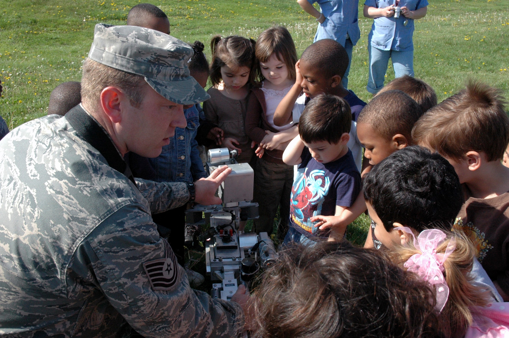Tech. Sgt. Vandiver Hood, explosives ordnance craftsman from the U.S. Air Force Expeditionary Center's 421st Combat Training Squadron at Fort Dix, N.J., shows children at the McGuire Air Force Base, N.J., child development center how a remote-operated EOD robot works April 24, 2008.  The demonstration was part of an effort by the 421st CTS who sent several Airmen to the CDCs at McGuire and Fort Dix for a tactical vehicle display and demonstration.  (U.S. Air Force Photo/Tech. Sgt. Scott T. Sturkol)