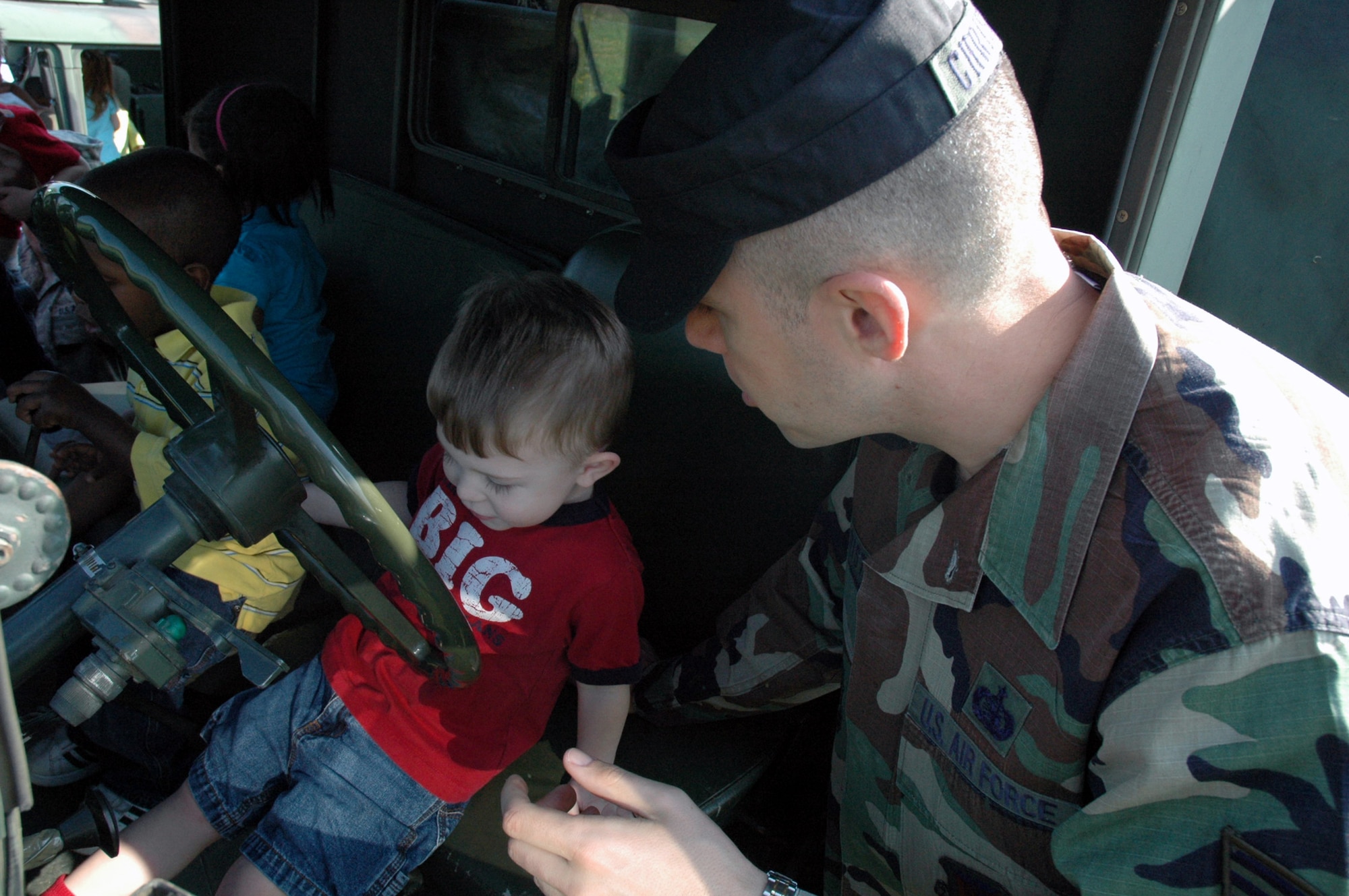 Tech. Sgt. Zachary Christman, from the U.S. Air Force Expeditionary Center's 421st Combat Training Squadron at Fort Dix, N.J., shows the inside of a HMMWV during a tactical vehicle display event at the McGuire Air Force Base (N.J.) child development center April 24, 2008.  Every year, Airmen from the 421st and the USAF EC take a day with military children at McGuire and Fort Dix CDCs to show them some of the equipment that is used by the military.  (U.S. Air Force Photo/Tech. Sgt. Scott T. Sturkol)