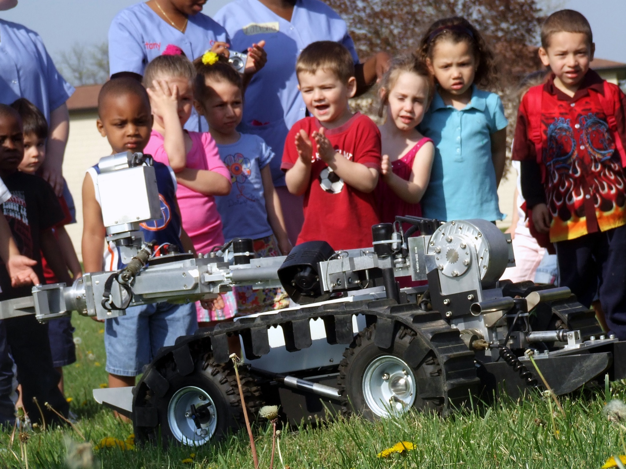 Children at the McGuire Air Force Base, N.J., child development center watch the movement of an explosives ordnance disposal robot as part of an tactical vehicle display event put on by the U.S. Air Force Expeditionary Center's 421st Combat Training Squadron April 24, 2008.  More than 150 children from the McGuire CDCs participated seeing HMMWVs and military trucks presented by numerous Airmen from the Center. (U.S. Air Force Photo/Macy Sturkol)