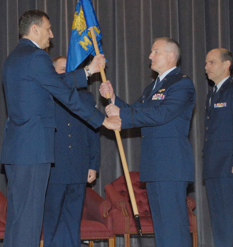 NIAGARA FALLS AIR RESERVE STATION, N.Y. -- Lt. Col. Timothy McCoy (center right) accepts the flag and thereby the command of the 914th Mission Support Group from 914th Airlift Wing commander Col. Reinhard Schmidt.  Lt. Col McCoy takes over the support group command job from Col. Kurt Hammer (pictured far right).  Lt. Col. McCoy comes to Niagara from Beale AFB, California and the 940th Mission Support Group.  (U.S. Air Force photo / Tech. Sgt. Christopher Boswell)