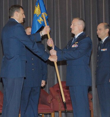 NIAGARA FALLS AIR RESERVE STATION, N.Y. -- Lt. Col. Timothy McCoy (center right) accepts the flag and thereby the command of the 914th Mission Support Group from 914th Airlift Wing commander Col. Reinhard Schmidt.  Lt. Col McCoy takes over the support group command job from Col. Kurt Hammer (pictured far right).  Lt. Col. McCoy comes to Niagara from Beale AFB, California and the 940th Mission Support Group.  (U.S. Air Force photo / Tech. Sgt. Christopher Boswell)