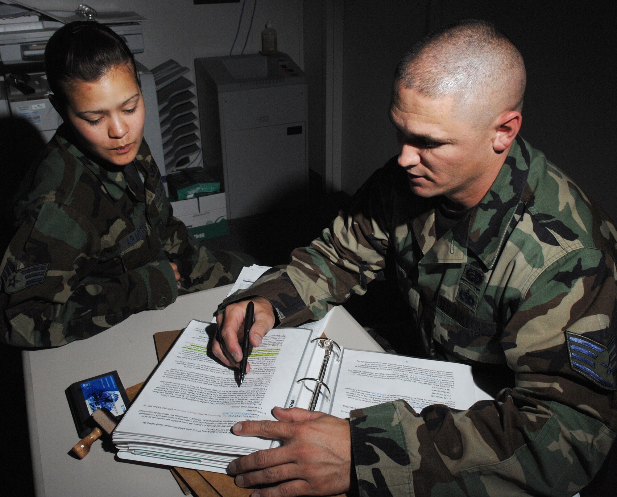 (Left to Right) Senior Airman Brandy Armstrong, 49th Civil Engineer Squadron, reviews her deployment orders with Staff Sergeant Jason Franklin, Assistant NCOIC, Installation Personnel Readiness Unit, 49th Force Support Squadron Apr 22, Holloman Air Force Base, N.M. (U.S. Air Force photo/Senior Airman Anthony Nelson Jr)