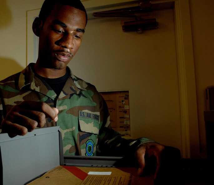 Airman 1st Class Sean Cooper, Reenlistments/Extensions journeymen, 49th Force Support Squadron reorganizes reenlistment folders Apr 22, Holloman Air Force Base, N.M. (U.S. Air Force photo/Senior Airman Anthony Nelson Jr)
