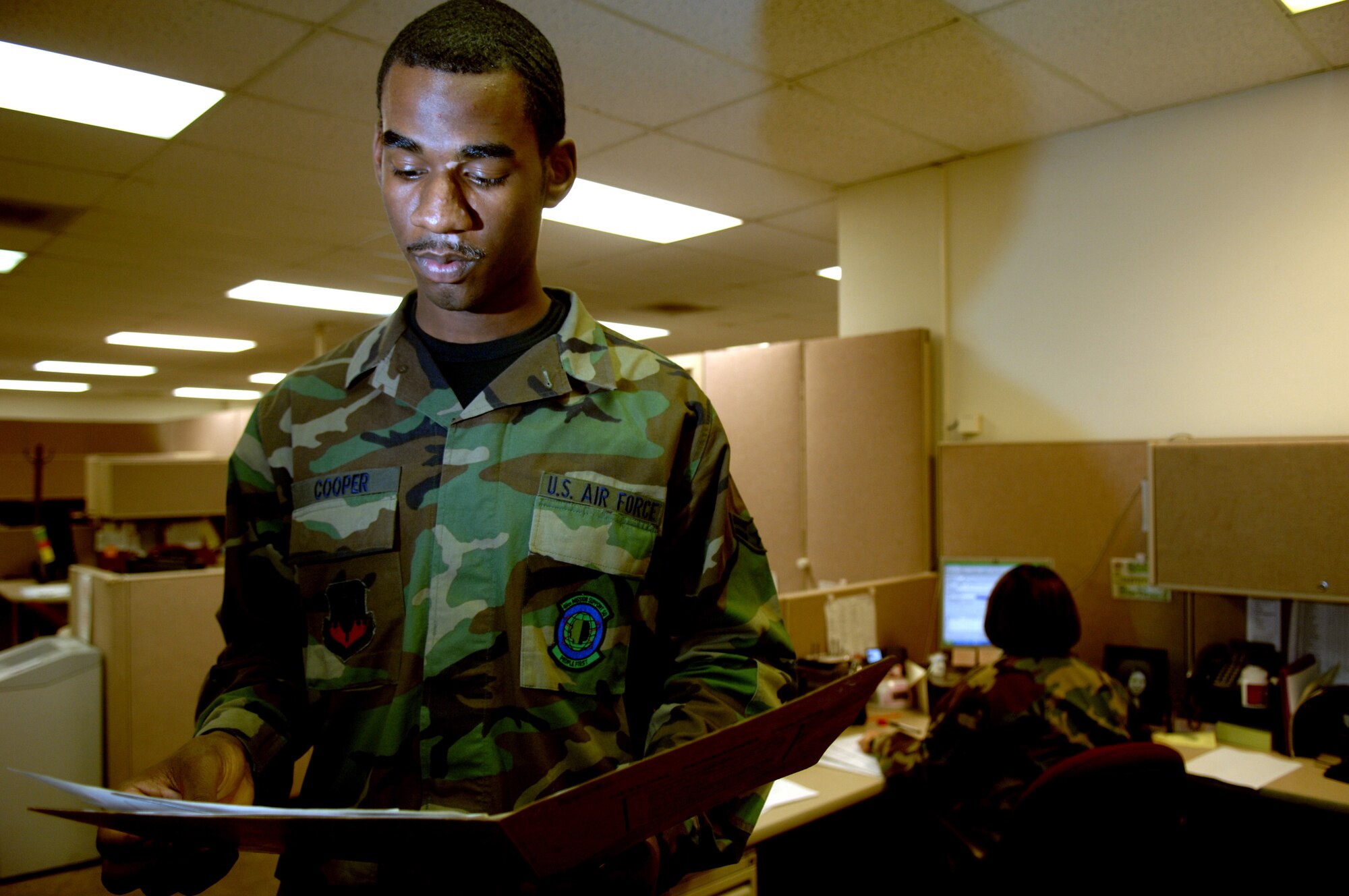 (Left to Right) Airman 1st Class Sean Cooper and Staff Sergeant Summer Burkhard  Reenlistments/Extensions journeymen, 49th Force Support Squadron review reenlistment folders for accuracy and discrepancies Apr 22, Holloman Air Force Base, N.M. (U.S. Air Force photo/Senior Airman Anthony Nelson Jr)
