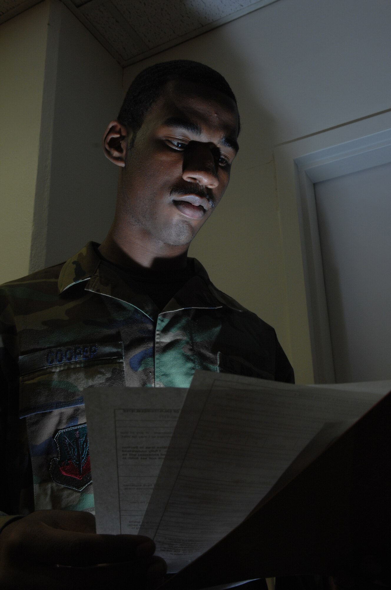 Airman 1st Class Sean Cooper, Reenlistments/Extensions journeymen, 49th Force Support Squadron reviews reenlistment folders for accuracy and discrepancies Apr 22, Holloman Air Force Base, N.M. (U.S. Air Force photo/Senior Airman Anthony Nelson Jr)

