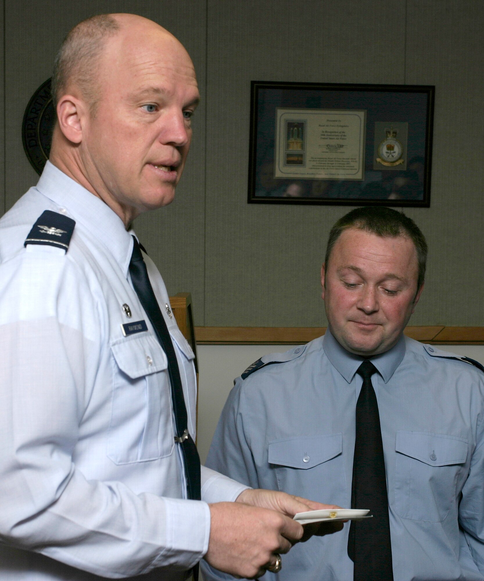 Col. Jay Raymond, 21st Space Wing commander (left), speaks with Royal Air Force Flt. Sgt. Jim Spurling during his visit to RAF Fylingdales DATE. Colonel Raymond was joined with Chief Master Sgt. Timothy Omdal, 21st SW command chief, and Senior Airman Ricardo Woods for a site visit of Fylingdales and the installation’s sister unit at RAF High Wycombe, located outside London. Both installations make up the U.K. Missile Warning Center that maintains a continuous missile warning capability for the U.S. and United Kingdom. (Royal Air Force photo/Flt. Lt. Chris Richardson) 