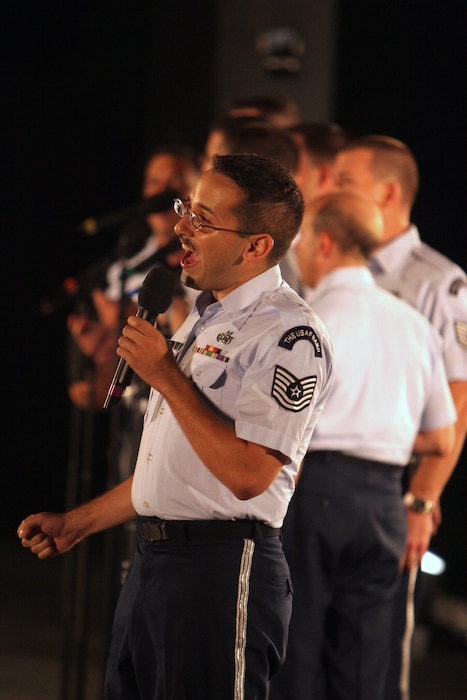 Tenor vocalist Technical Sgt. Joseph Haughton performs with the Men's Chorus of the Singing Sergeants and the USAF Concert Band at the Air Force Memorial in August 2007. During the summer months, different components of the USAF Band provide free public concerts at the base of the Air Force Memorial in Arlington, Va. (Official Air Force photo by Senior Master Sgt. Robert Mesite)