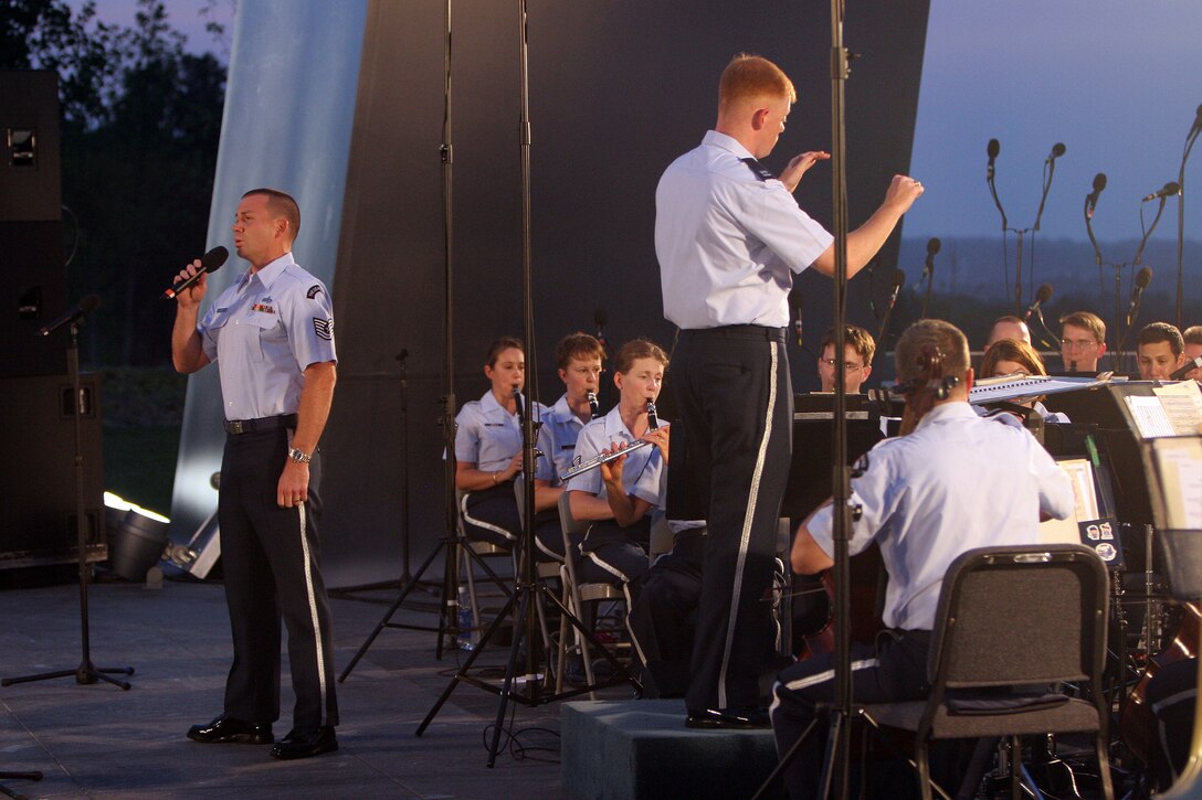 Tenor vocalist Technical Sgt. Taylor Armstrong performs in August 2007 at a summer concert with the USAF Concert Band at the Air Force Memorial. During the summer months, different components of the USAF Band provide free public concerts at the base of the Air Force Memorial in Arlington, Va. (Official Air Force photo by Senior Master Sgt. Robert Mesite)