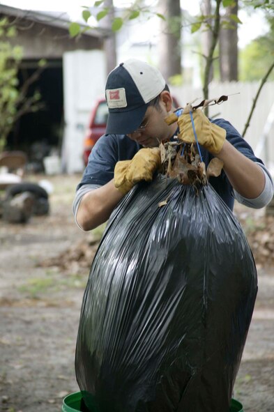 SUMTER, S.C.-- Staff Sgt. Sam Casares, 20th Maintenance Operations Squadron Weapons Standardization Section, pulls up a bag of leaves at a hospice care residence April 19. Several members from the WSS volunteer quarterly to help with yard work and repairs for veterans in hospice care in the Sumter community. (U.S. Air Force photo/Staff Sgt. Holly Brown)