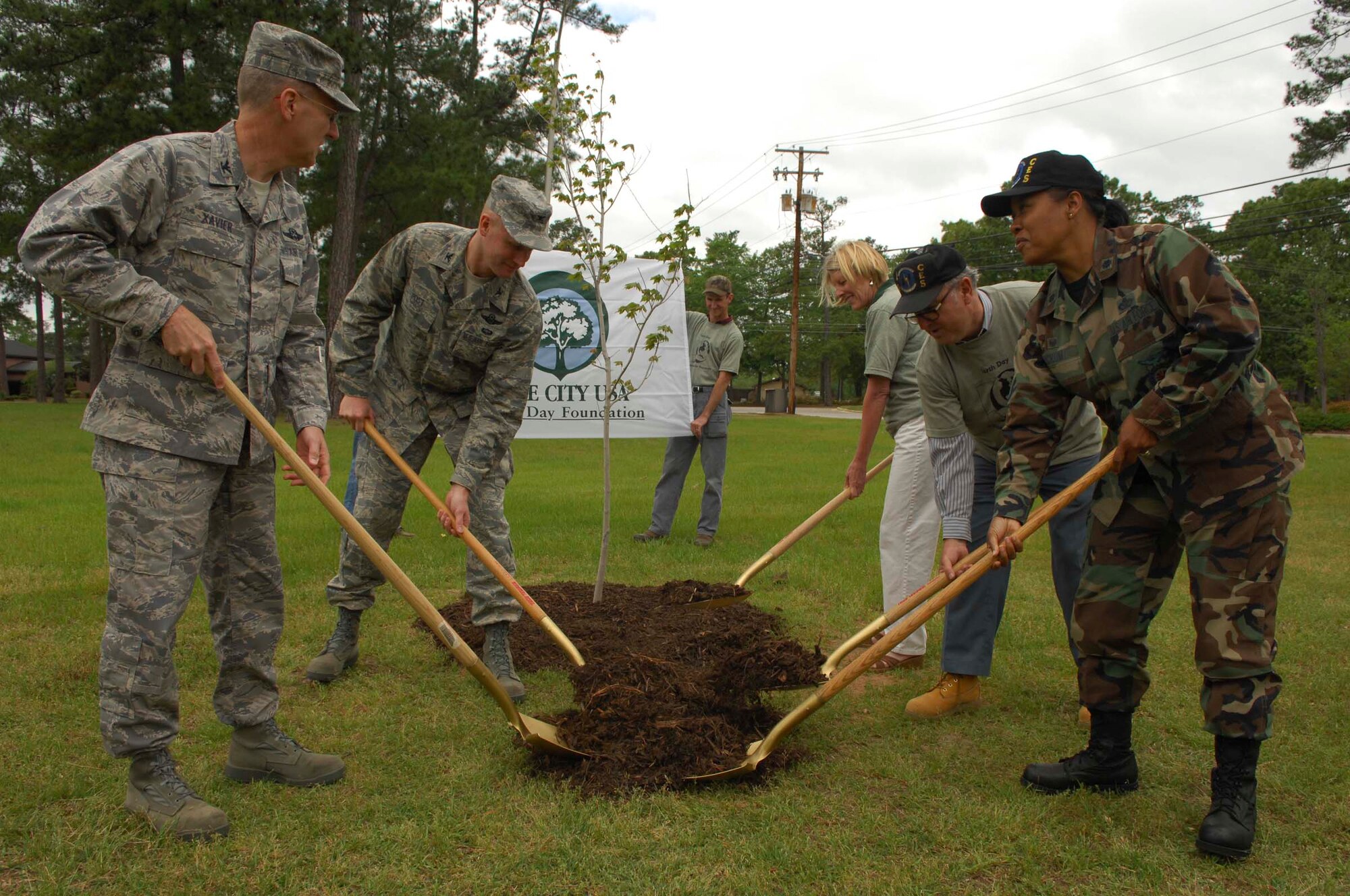SHAW AIR FORCE BASE, S.C.-- Col. Francis Xavier, 20th Mission Support Group commander; Col. James Post, 20th Fighter Wing commander; Mrs. Lois Edwards, South Carolina Forestry Commission; Mr. Doug Back, 20th Civil Engineering Squadron base forester and Lt. Col. Jacqueline Crum 20th CES commander, toss mulch on a freshly planted red maple tree with ceremonial shovels in a clearing adjacent to the Fitness Center April 22. The tree was planted in honor of Arbor Day and for Shaw being recognized as a Tree City for the eighth consecutive year. (U.S. Air Force photo/Staff Sgt. Henry Hoegen)