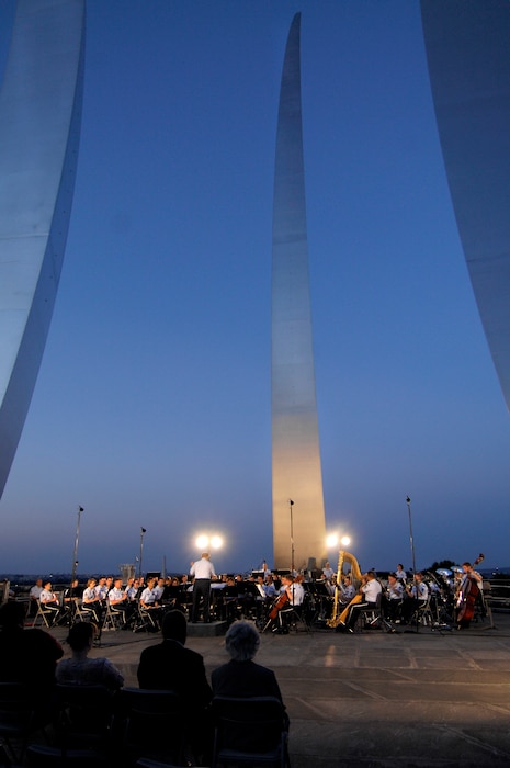 The USAF Concert Band performs an outdoor concert with the Band's Conductor Emeritus, Col. Arnald D. Gabriel. During the summer months, different components of the USAF Band perform at the base of the Air Force Memorial in Arlington, Va.