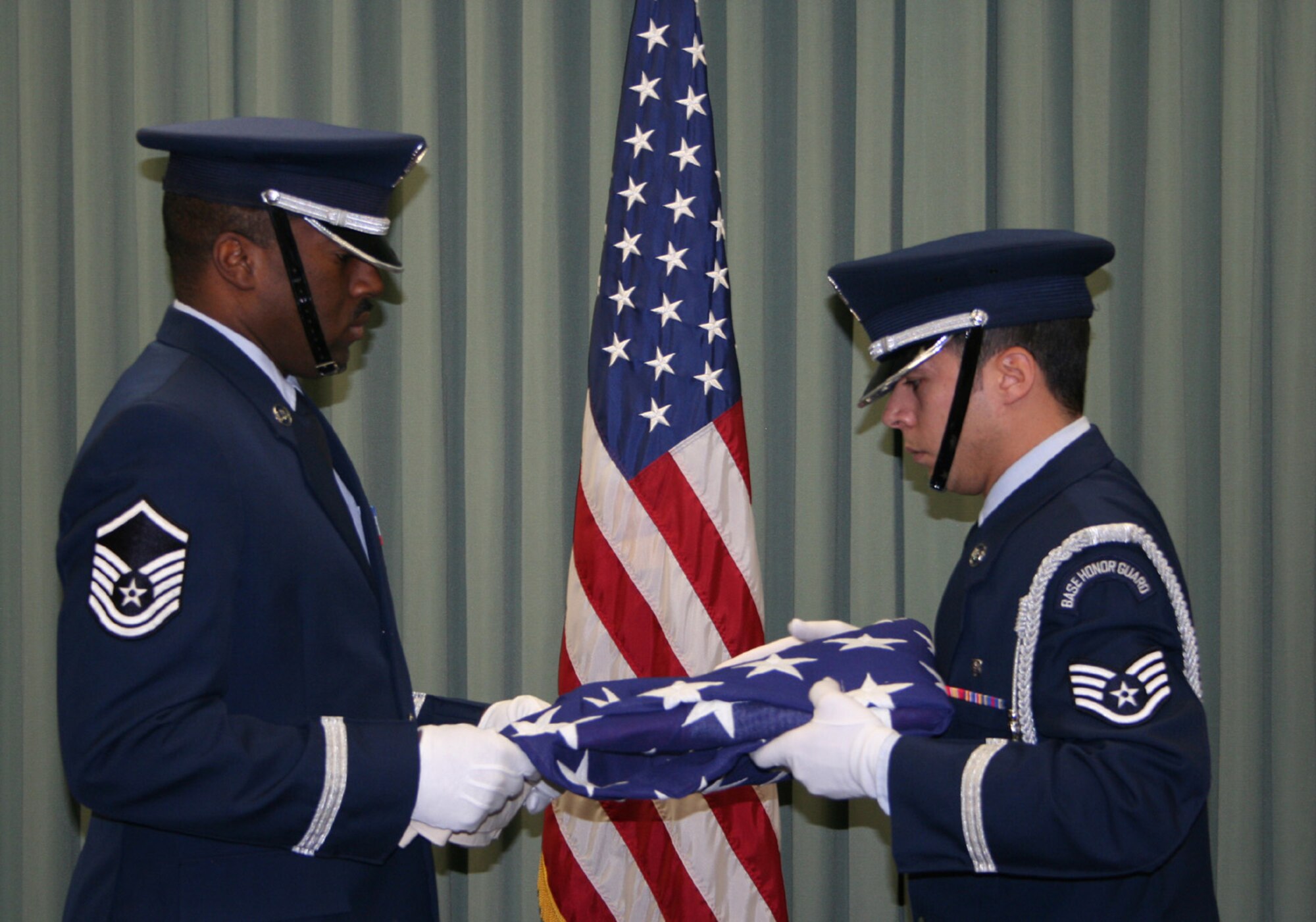 WRIGHT-PATTERSON AFB, Ohio - Master Sgt. Mark Lyle and Staff Sgt. Jimmy Montalvo, Jr. of the 445th Airlift Wing Honor Guard fold a flag during a recent retirement ceremony.  (U.S. Air Force photo/Senior Airman Ken LaRock)
