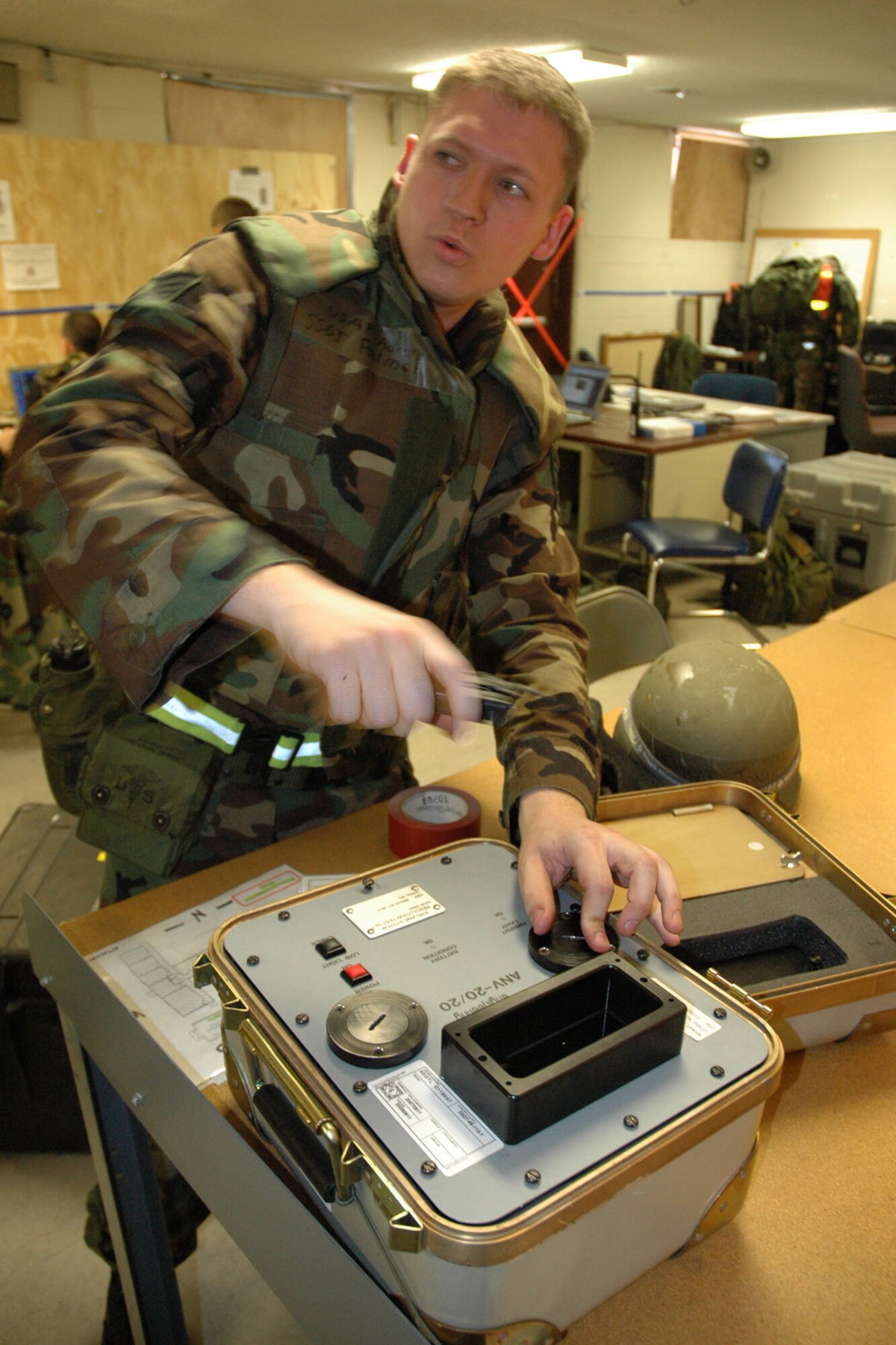 GULFPORT COMBAT READINESS TRAINING CENTER, Miss. -- Staff Sgt. Aaron Palmer, an Aircrew Flight Equipment craftsman, makes adjustments to a Night Vision Goggle testing device.  The instrument is used to properly sight Night Vision Goggles used by aircrew members when flying at night.  U.S. Air Force photo/Master Sgt. Bryan Ripple