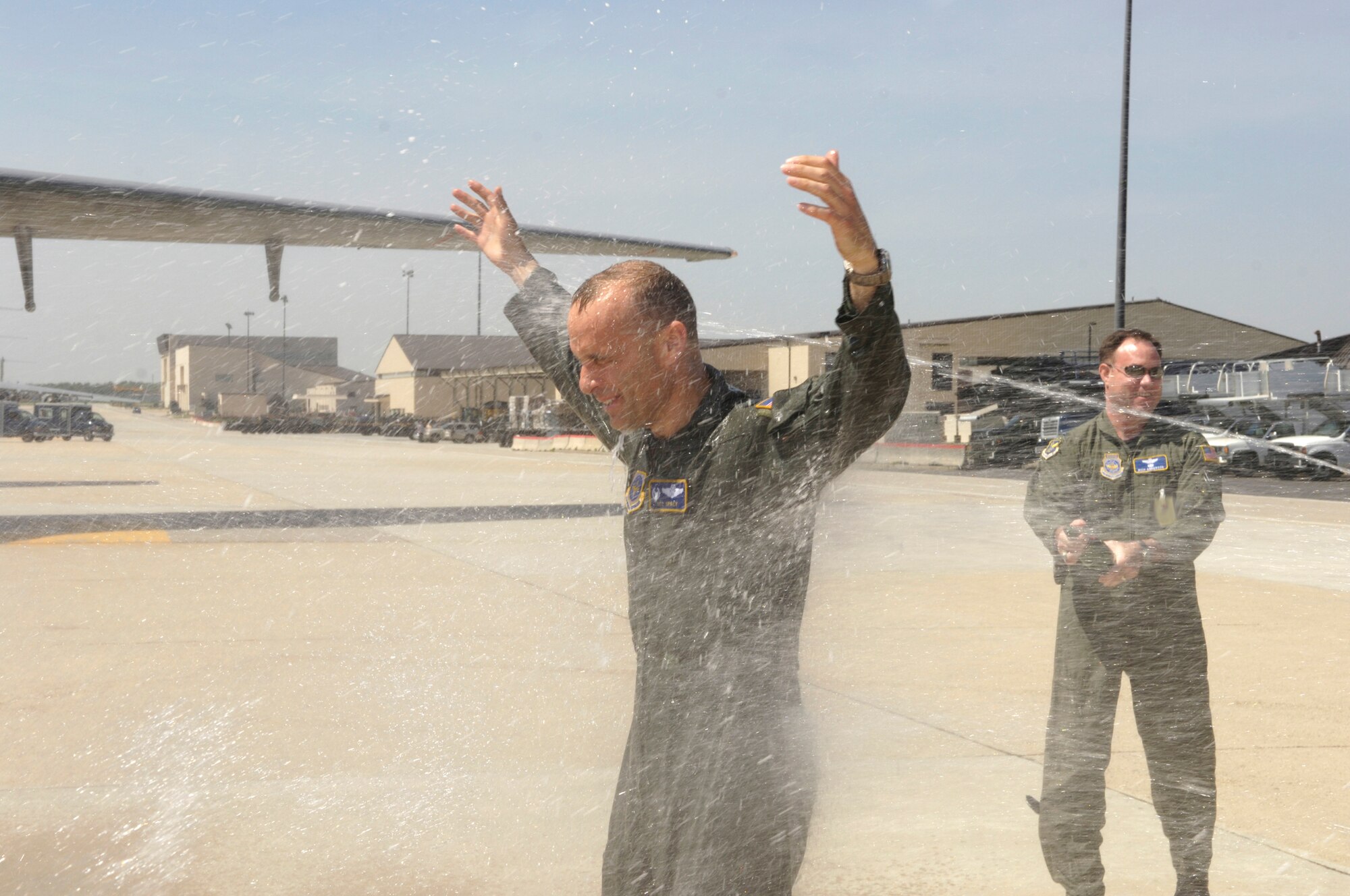 Col. Bill Spacy, 305th Air Mobility Wing vice commander, is hosed down after his fini-flight here recently. Colonel Spacy is moving on to Scott Air Force Base, Ill. (U.S Air Force photo/Kenn Mann)