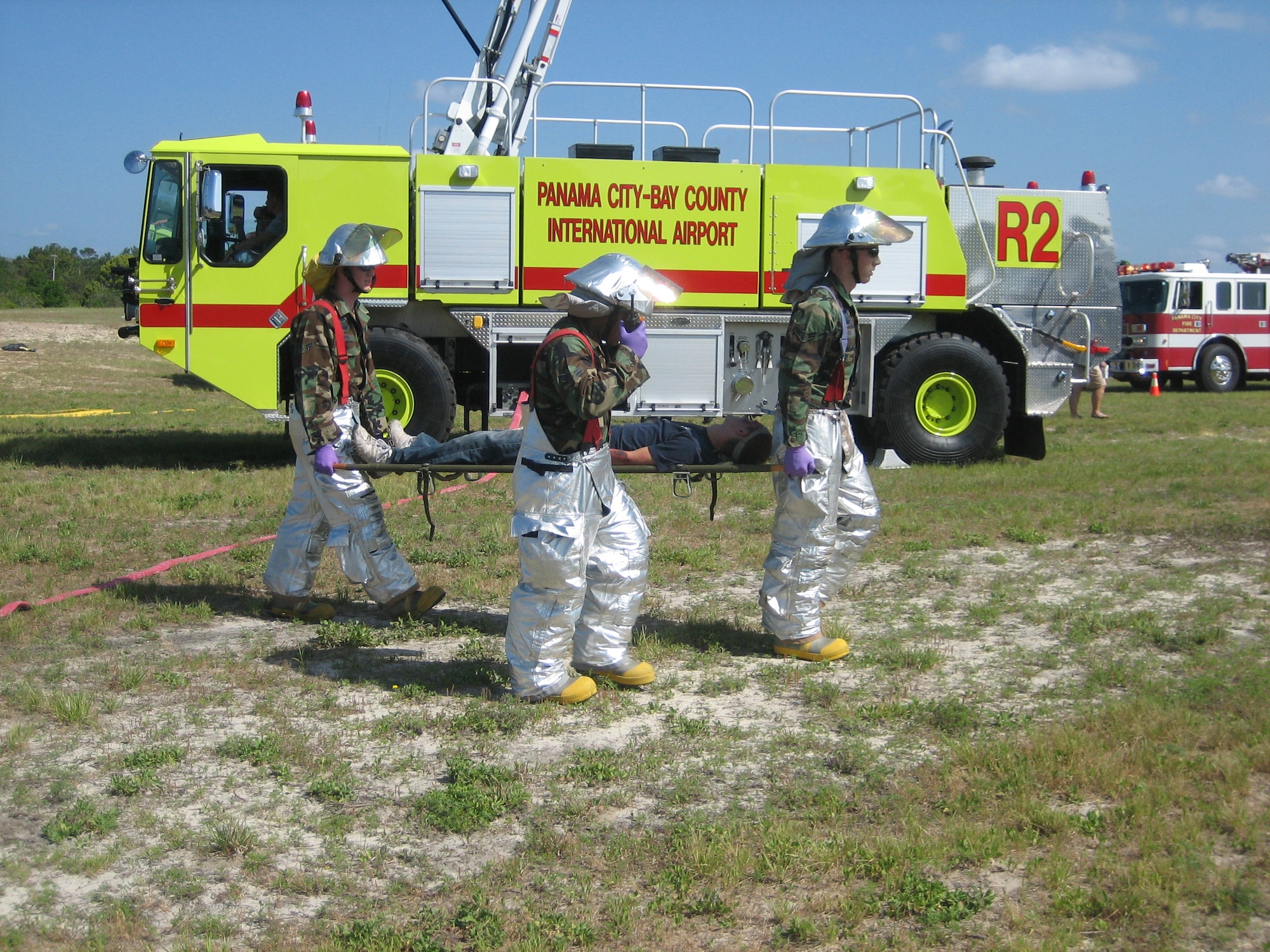 Fire protection specialists from the 325th Civil Engineer Squadron carry an injured victim to a designed location to receive treatment during a joint training exercise April 25 at the Panama City Airport. Tyndall fire fighters and medical personnel participated in the training exercise with Bay County emergency response agencies.
