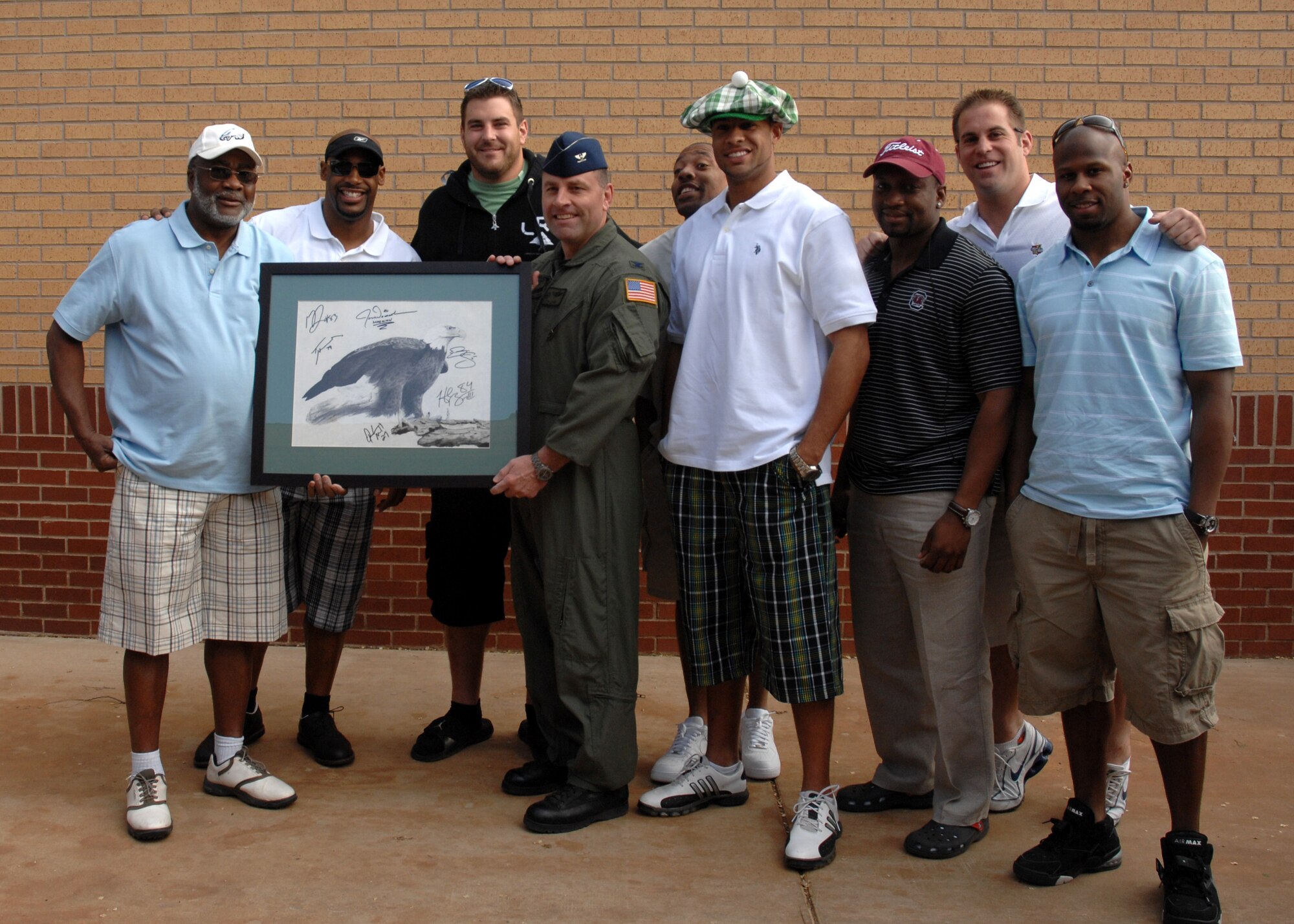CANNON AIR FORCE BASE N.M.--  Col. Timothy J. Leahy, 27th Special Operations Wing commander, receives a locally designed eagle graphic autographed by members of the Philadelphia Eagles April 19.  The event took place at the Whispering Winds Golf Course during the annual Oasis Golf Tournament. (U.S. Air Force photo/Airman 1st Class Evelyn Chavez)  