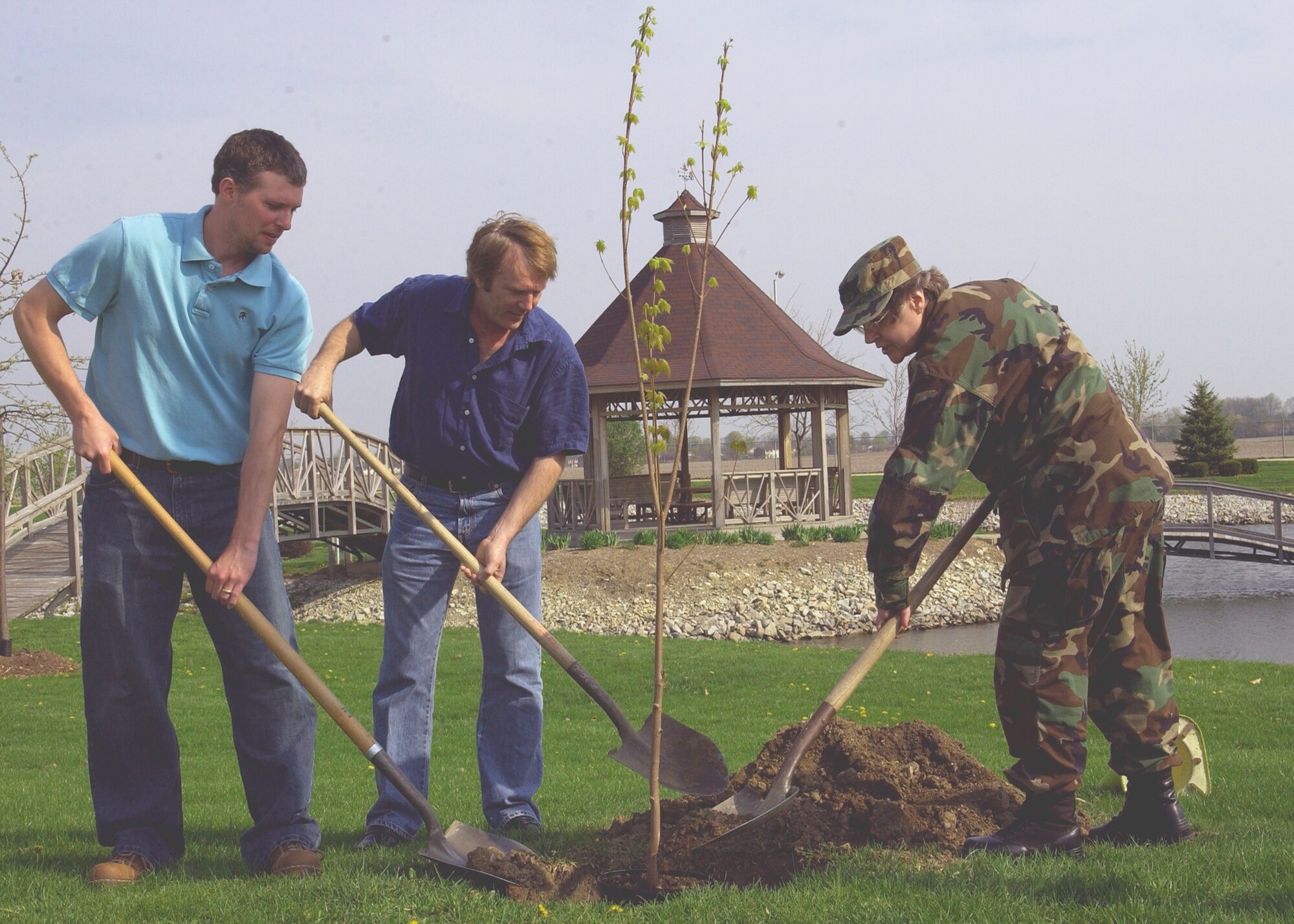 GRISSOM AIR RESERVE BASE, Ind., -- Members of the 434th Support Group, from left, Corey Walters, Bob Goodall, and Col. Betty Bowen, 434th Support Group commander, plant a tree just south of the pond near the civil engineering complex. The planting was in observance of Arbor Day. (U.S. Air Force photo/Tech. Sgt. Doug Hays)                       