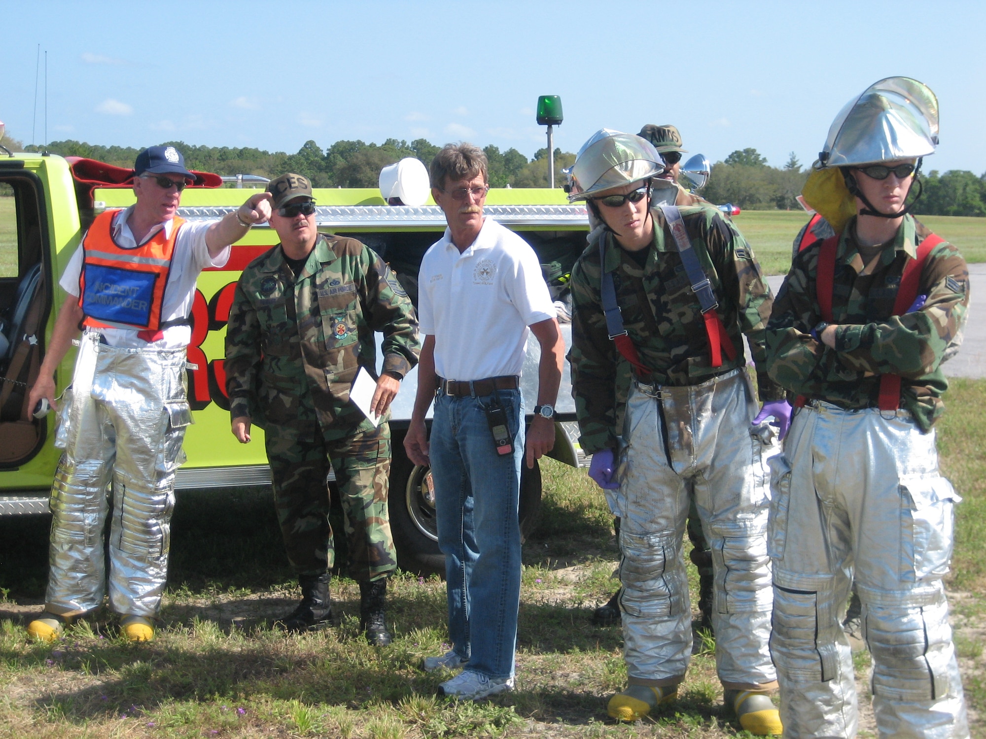 Tyndall fire fighters and medical personnel participated in a joint training exercise with Bay County emergency response agencies April 25 at the Panama City Airport. Here, the Bay County Fire Department's fire chief and incident commander, briefs Tyndall emergency responders on the situation and coordinates the proper response to a simulated plane crash. 