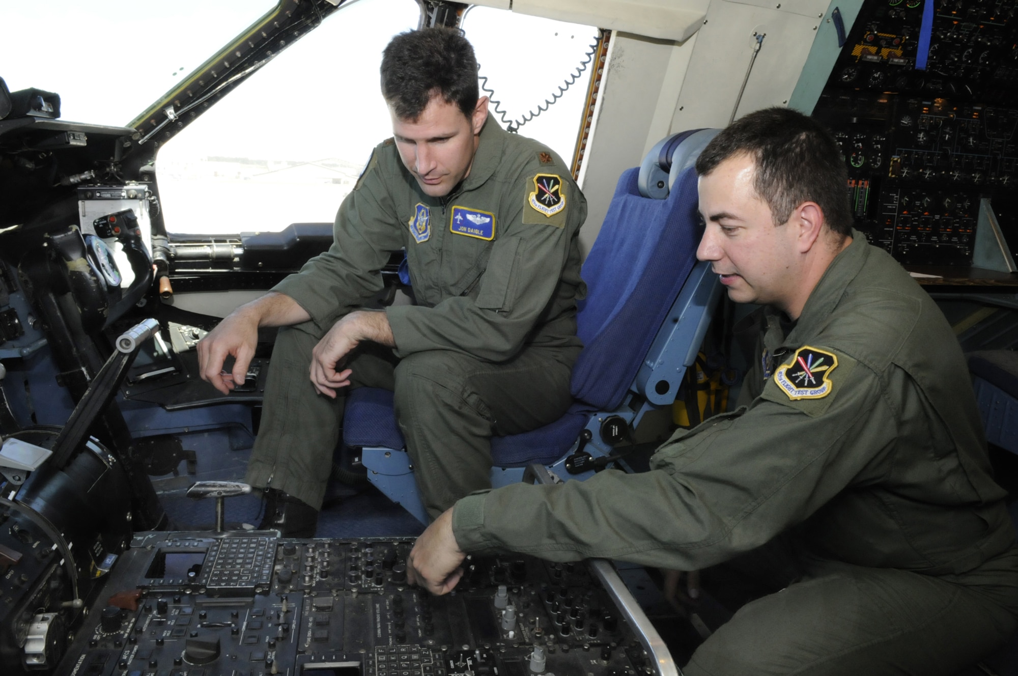 Maj. Jon Daigle, pilot, and MSgt. Pat Cioffi, flight engineer, discuss pre-flight checks on a  C-5. U. S. Air Force photo by Sue Sapp