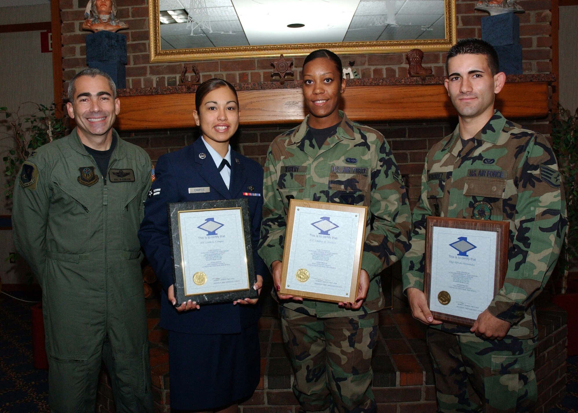 CANNON AIR FORCE BASE N.M. - (Left to right) Col. Valentino Bagnani III, 27th Special Operations Wing vice commander, stands next to Airman 1st Class Linda Campos, 27th Special Operations Services Squadron, Airman 1st Class  Lindsay Herbert, 27th Special Operations Maintenance Operation Squadron, and Staff Sgt. Alfredo Hernandez, 27th Special Operations Civil Engineer Squadron, who received  Diamond Sharp awards at the Pecos Trail Dinning Facility on April 25. Diamond Sharp awards are presented to Airmen for exellence on and off duty. (U.S. Air Force photo by Elizabeth Merchant)                       