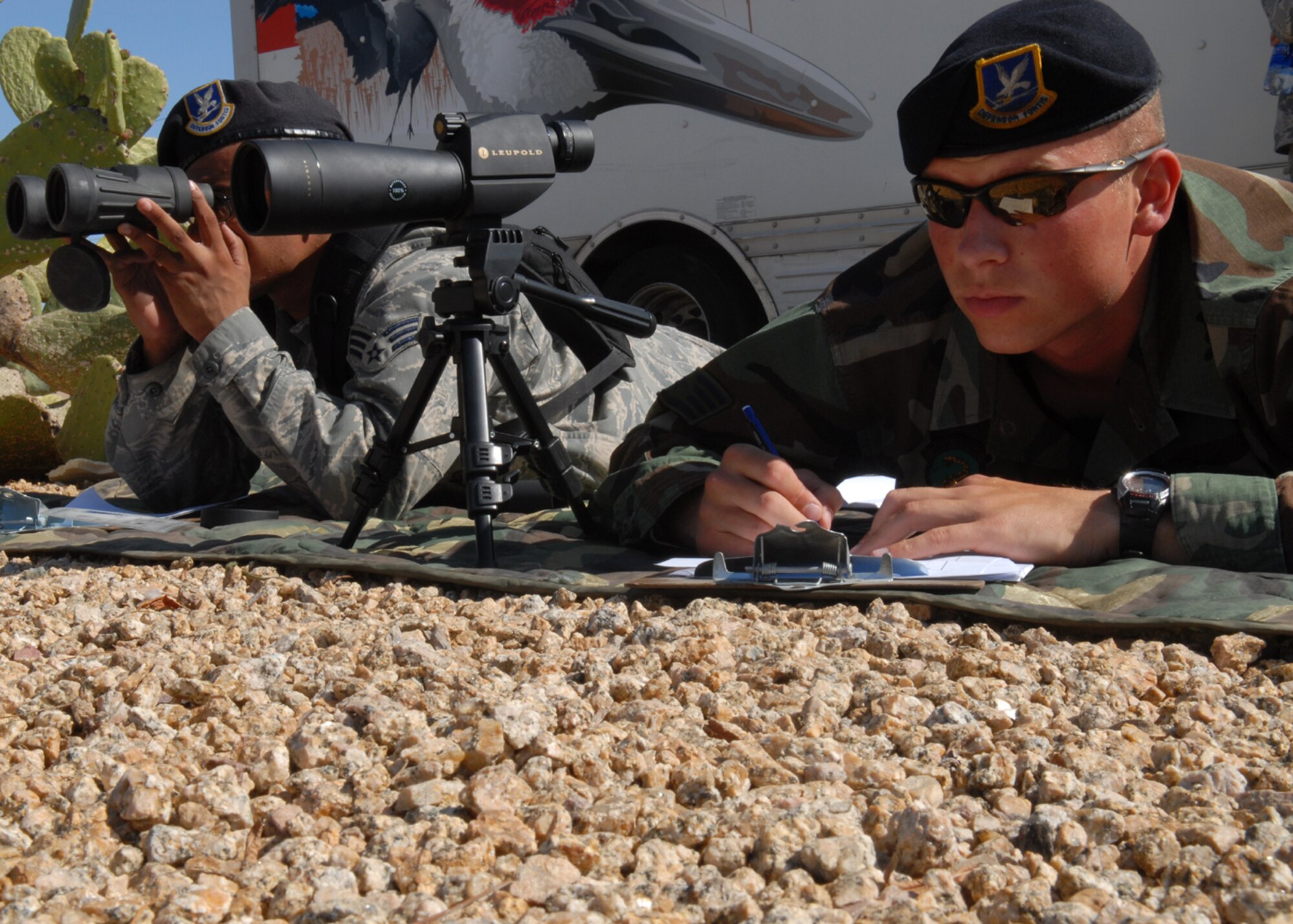 Staff Sgt. Anthony Quinn, a patrolman from the 56th Security Forces Squadron and Senior Airman Benny Prescott, a 56th SFS desk sergeant, train on Target Detection and Sketching to prepare them for Close Precision Engagement training on April 3. Target Detection and Sketching are two kinds of techniques used by sharpshooters and is used to find small objects and potential targets. (U.S. Air Force photo/Airman 1st Class Gustavo Gonzalez)