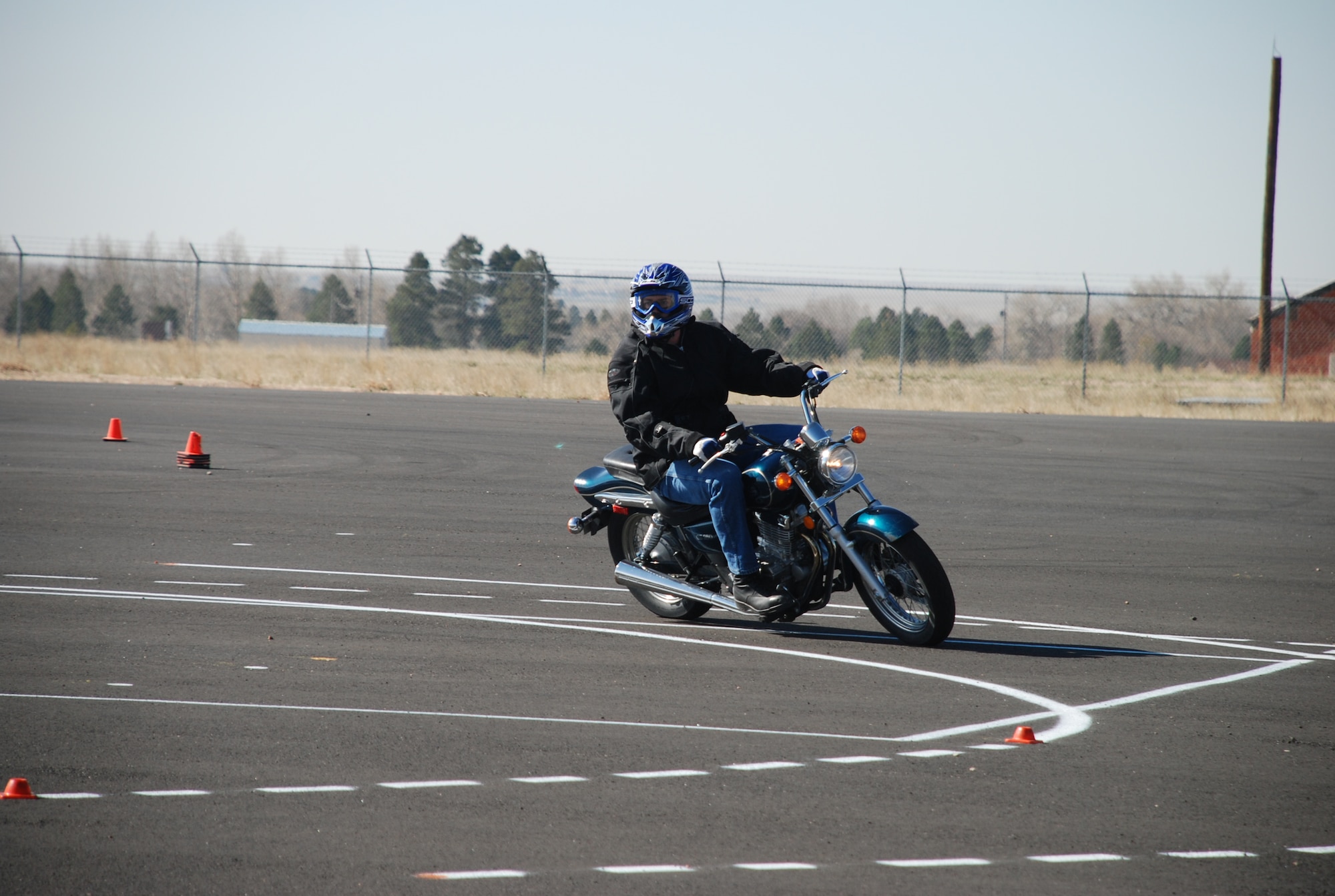 A student performs a cornering maneuver Wednesday during the practical portion of the motorcycle safety course. When taking a turn it is important to remember to look to the end of the turn and trust that the motorcycle won't fall over.