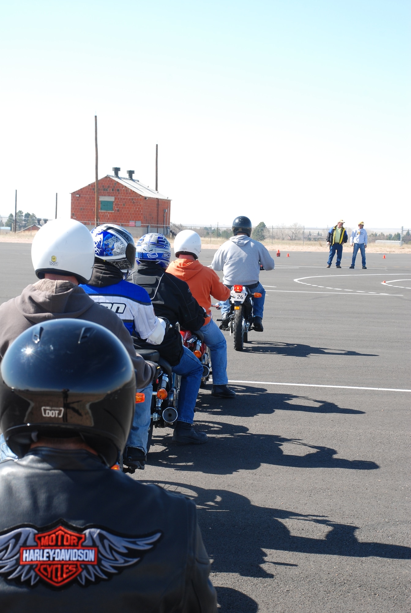 Students begin the graded portion of the motorcycle safety course Wednesday at the base driver's training pad with a practical exam in braking while making a turn. It is important to remember to straighten the wheel out before applying the brake, and to apply an even pressure on both the front and rear brake.