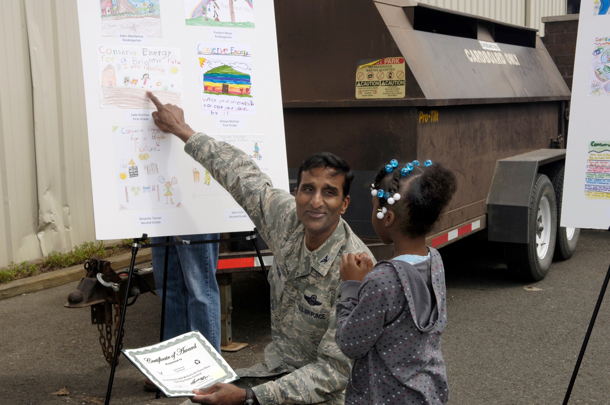 Col. Balan Ayyar, 305th Air Mobility Wing commander, looks at Jada German’s winning artwork in the 2008 McGuire Earth Day Poster Contest here recently. The contest was part of the McGuire Earth Week celebration. (U.S Air Force photo/Kenn Mann)