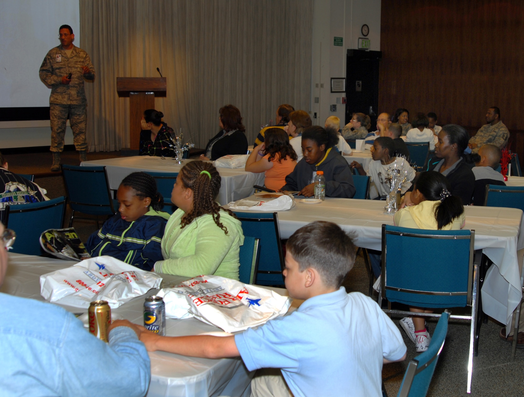 Children and their parents receive a kids' version of the Air Reserve Personnel Center mission brief during Bring Your Child to Work Day at ARPC on April 24. The annual event allows children, ages 8 to 14, to accompany their parents or grandparents to work and learn about their careers. (U.S. Air Force photo/Ellen Edwards)