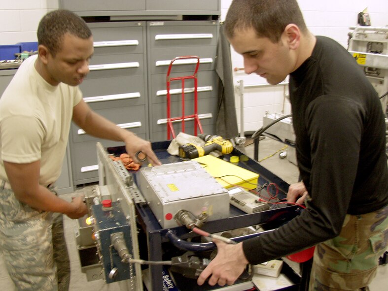 Tech. Sgt. Derrick Page, 90th Maintenance Operations Squadron, and Senior Airman Roland Dorta, 90th Missile Maintenance Squadron, inspect machinery in preparation for the Guardian Challenge.